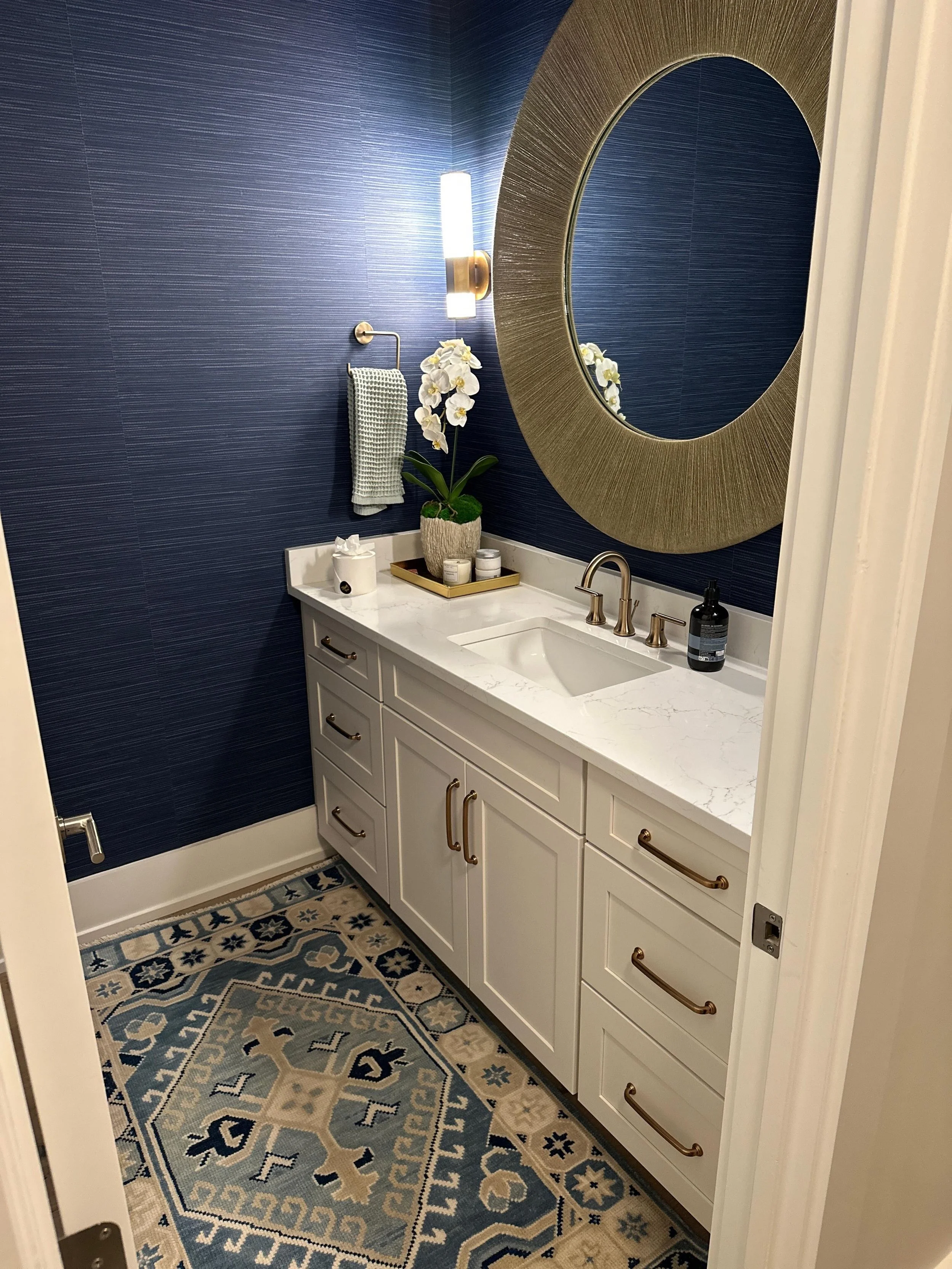 Still blue with envy over this fun navy powder bath. Camera 📷 angles are tough sometimes but the room extends behind this door to a unique storage cabinet. We let this amazing vinyl paper from @thibaut_1886 be our punch and speckled in curated items