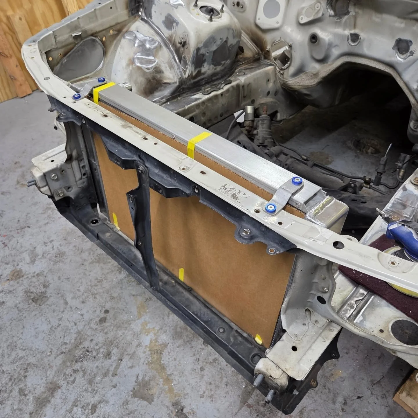 Little update. Had a bit of freetime today and jabbed this @championcoolingsystems radiator in my #jzx100mkll i was determined to fit the biggest radiator I could squeeze between the rails and still had to cut one of the end tanks down to make it a t