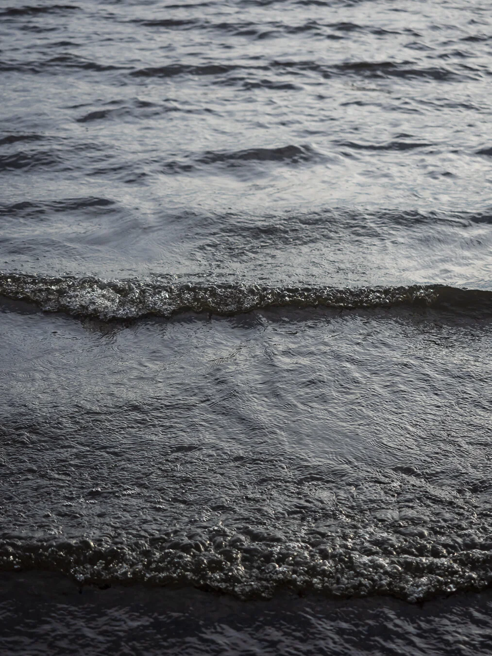 On this day at the beach it was extremely windy so it was causing ripples in the lake.