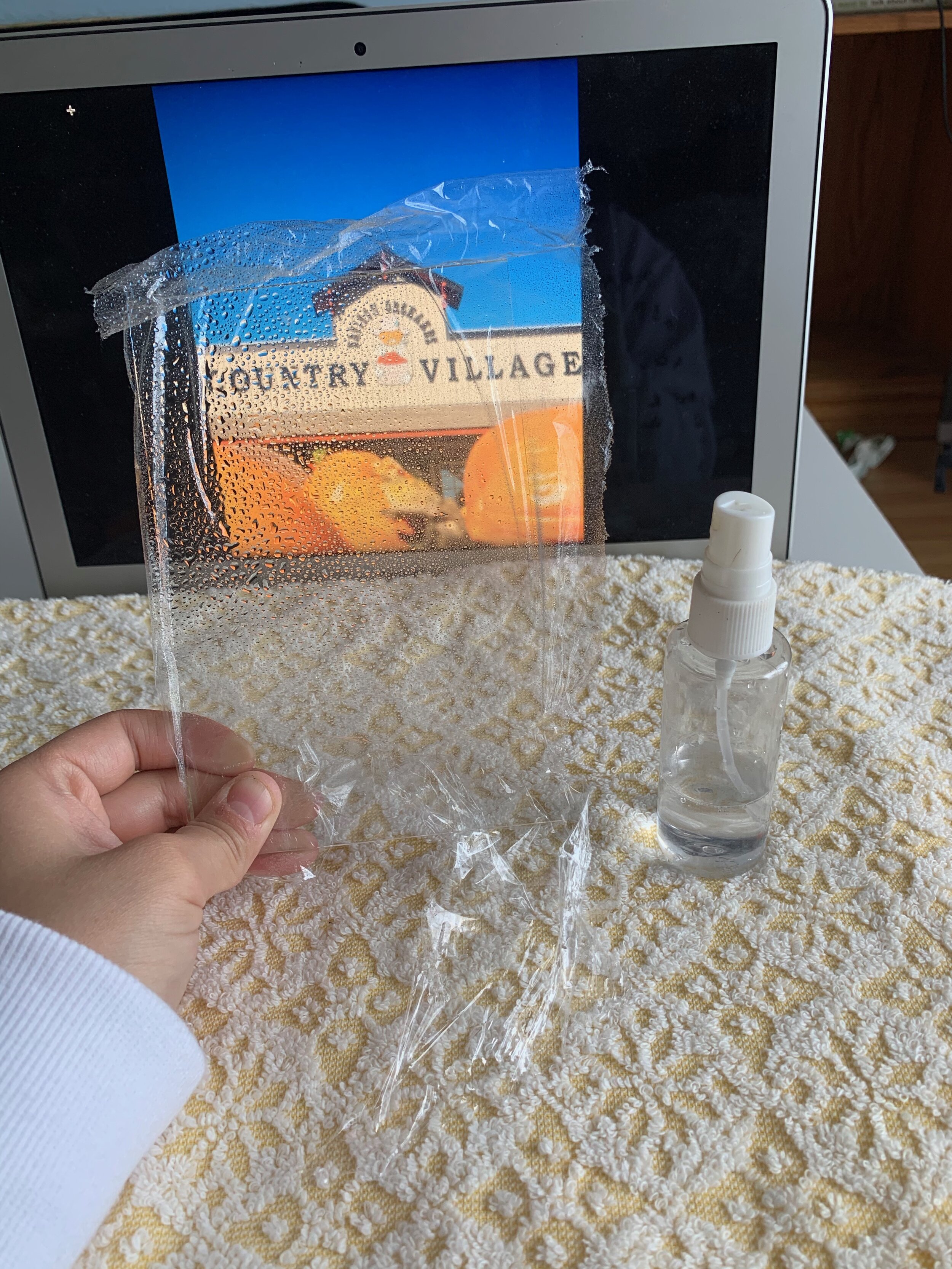 By spraying water on the plastic vs. straight on the glass it will form better droplets (based on my experience)