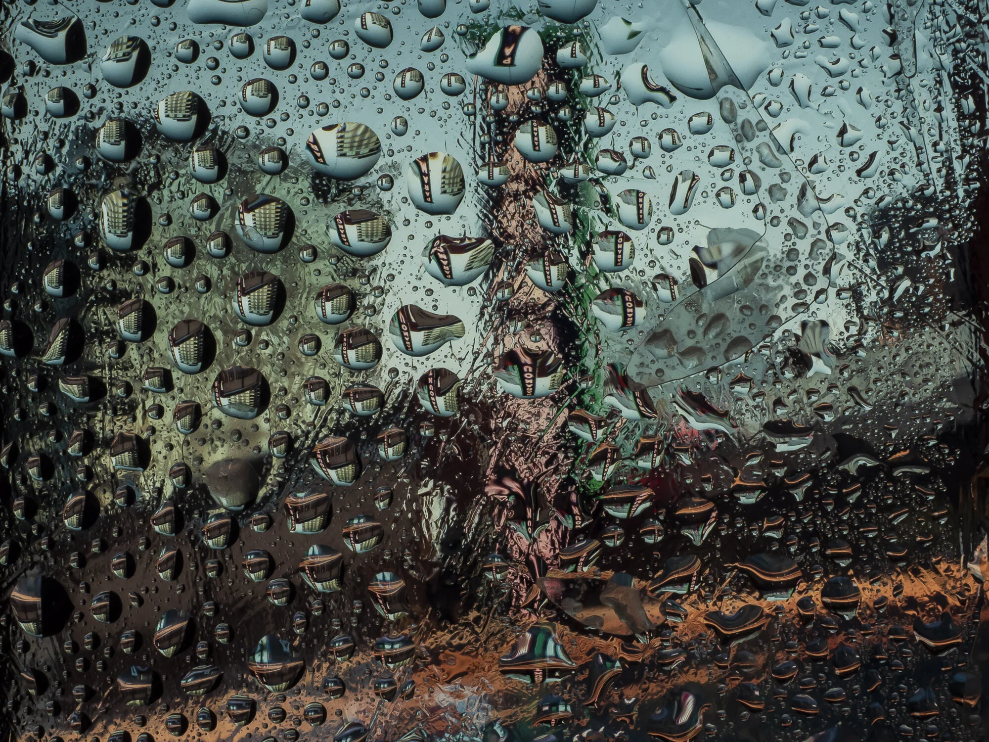 Exploring refraction photography, taken inside my home using a laptop with my age, some glass and water droplets!