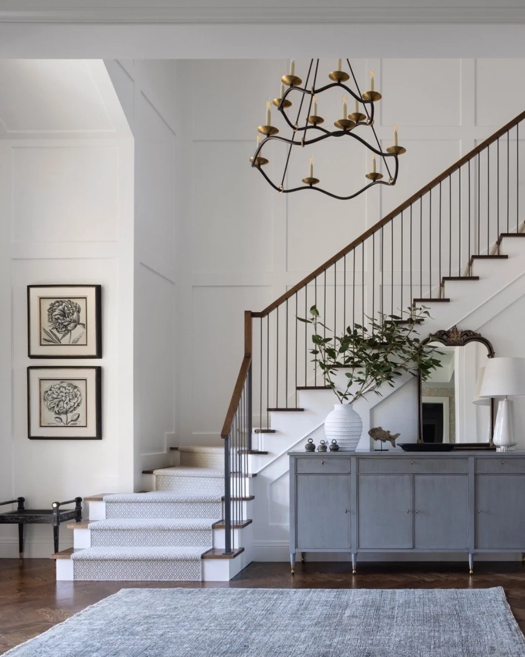 The moment you step inside, this foyer welcomes you with balance and quiet sophistication. Clean architectural lines, layered textures, and a soft palette create a sense of calm while brass accents and tailored detailing add just the right touch of d