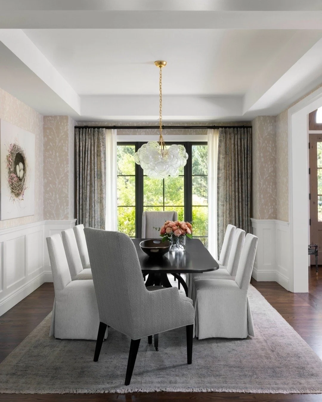A dining space designed to invite conversation, connection, and calm. Soft neutral tones, layered textures, and natural light create an atmosphere that feels both sophisticated and effortless.
We paired tailored slipcovered chairs with a sculptural