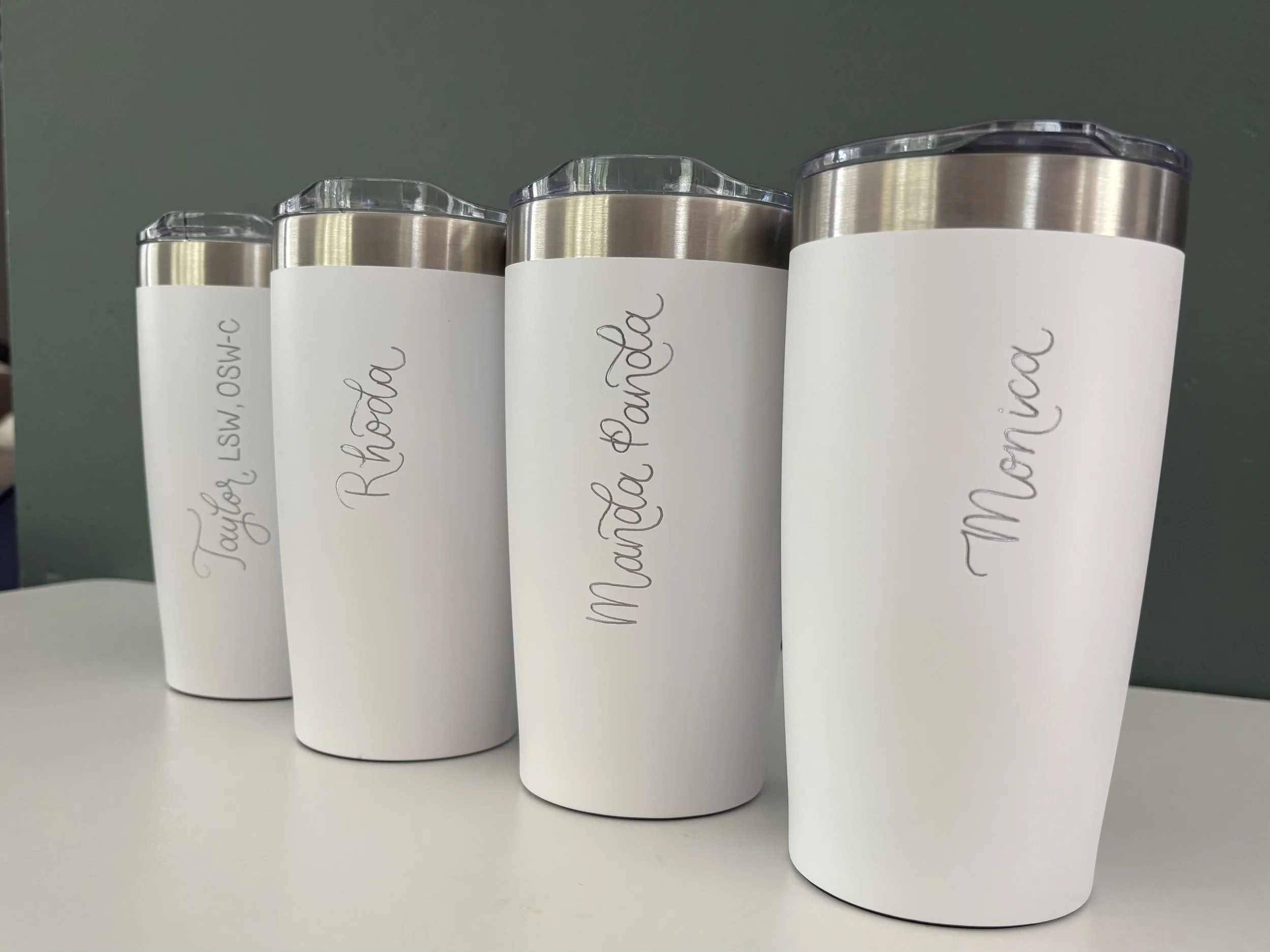white travel mugs engraved with names in calligraphy