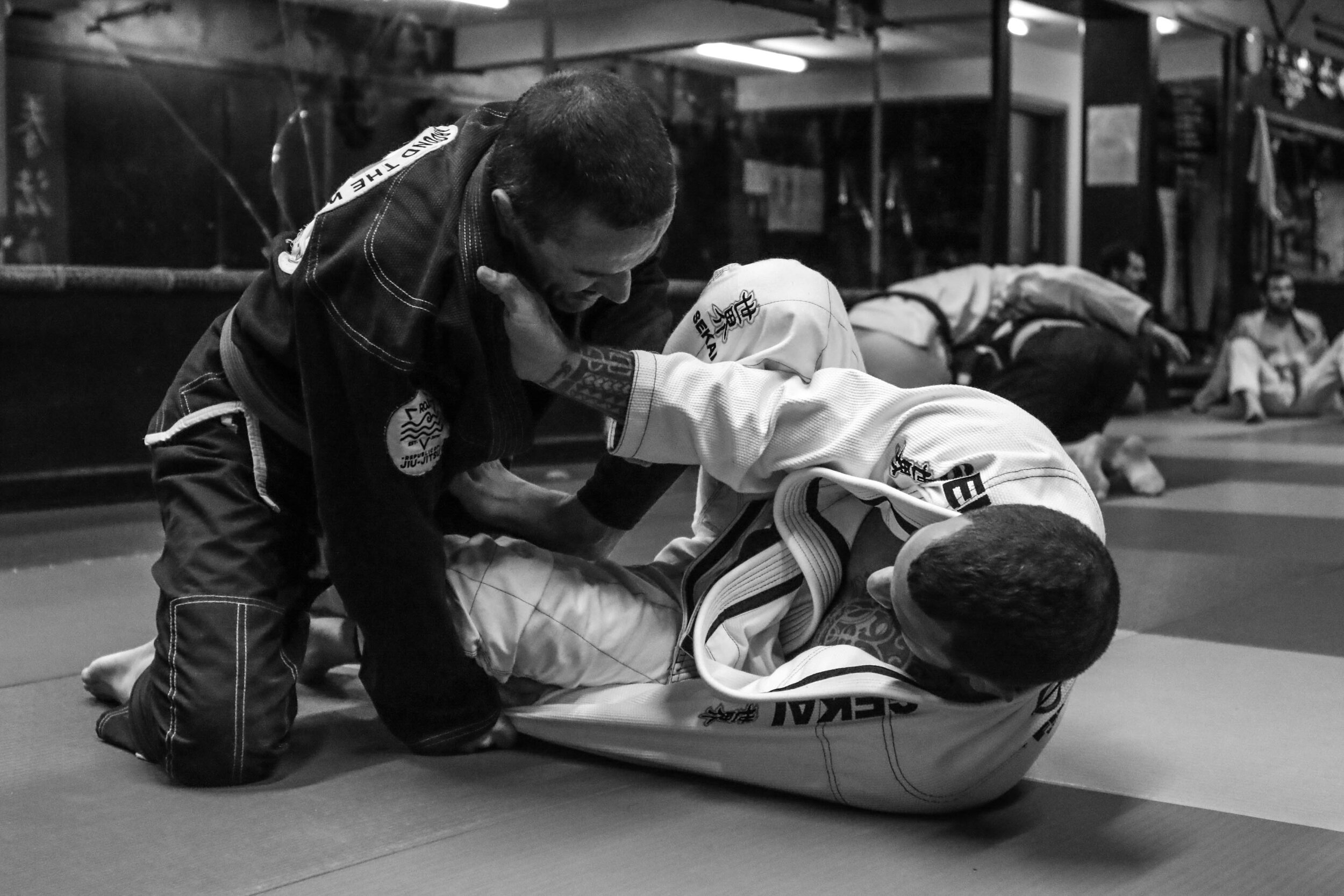 BJJ coach and student sparring 