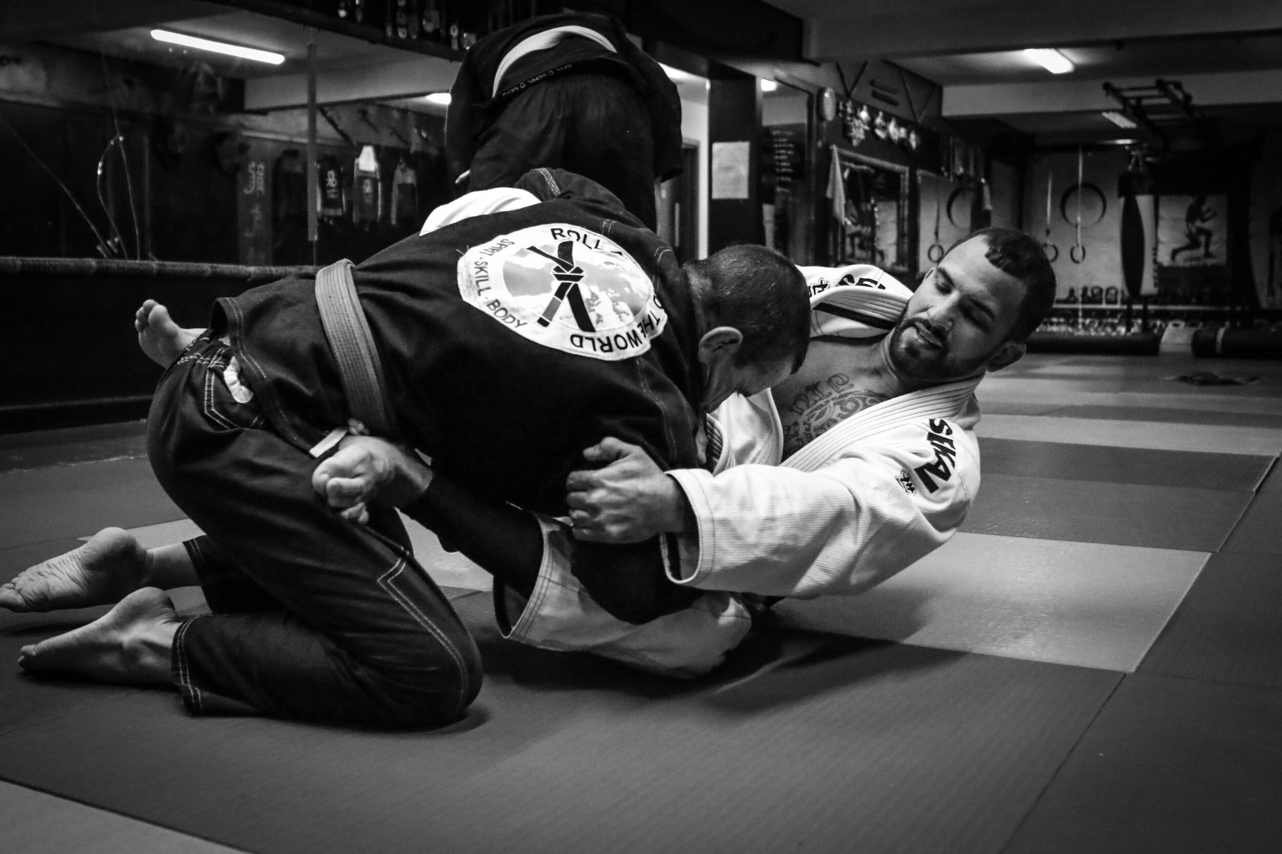 BJJ coach and student sparring 