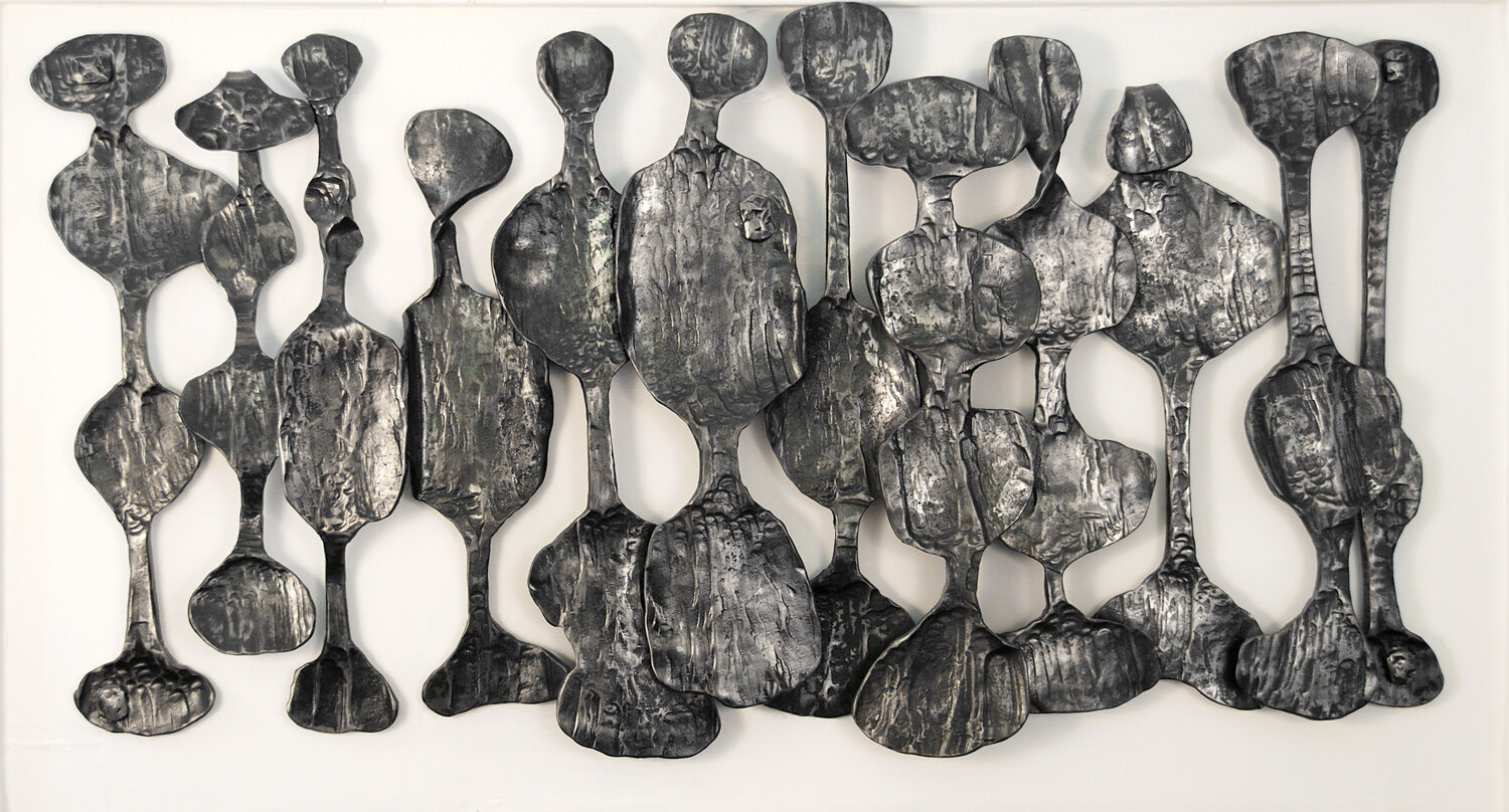  African Art-inspired wall relief sculpture. This residential artwork of forged steel designed by Dimitri Gerakaris to resonate with the room full of antique African art. 