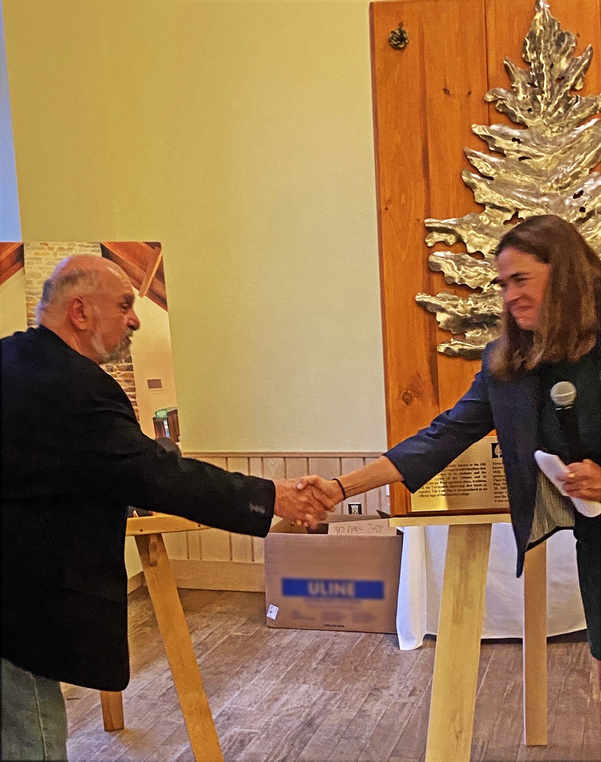  LONE PINE sculpture formally accepted from artist, Dimitri Gerakaris, left,  by Sian Beilock, President of Dartmouth College 