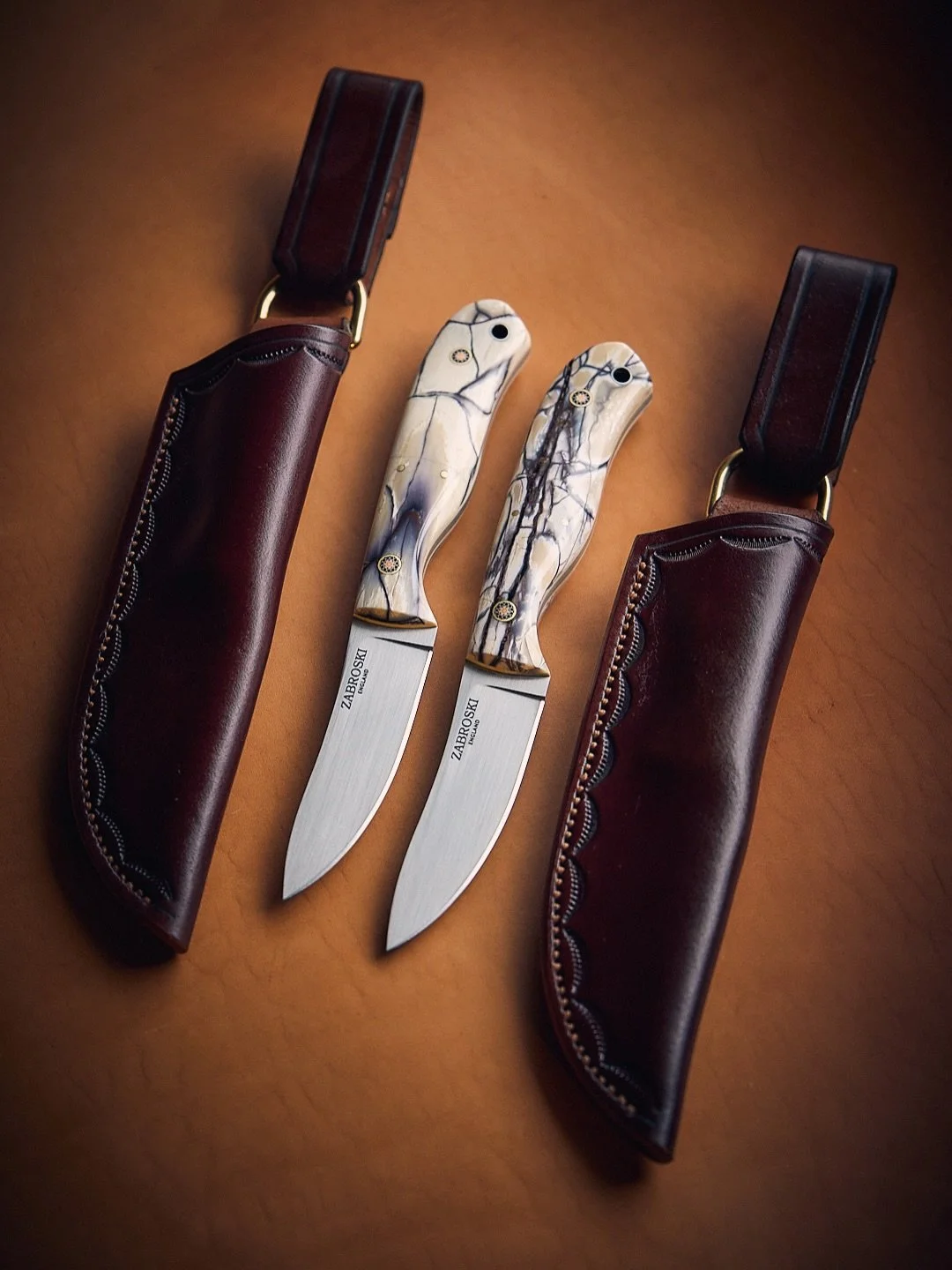 Father &amp; Son.

Deerstalker - matched pair in RWL34 stainless, with Woolly Mammoth Ivory handles lined in Ivory G10.

As requested, this custom order was finished with matching sheaths compete with &lsquo;dangler&rsquo; belt loops. 

Already put t