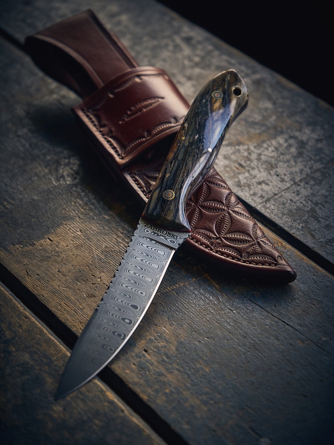 Custom Huntsman model

4.5&rdquo; Damasteel stainless &lsquo;Damascus&rsquo; blade with Woolly Mammoth Ivory handles.