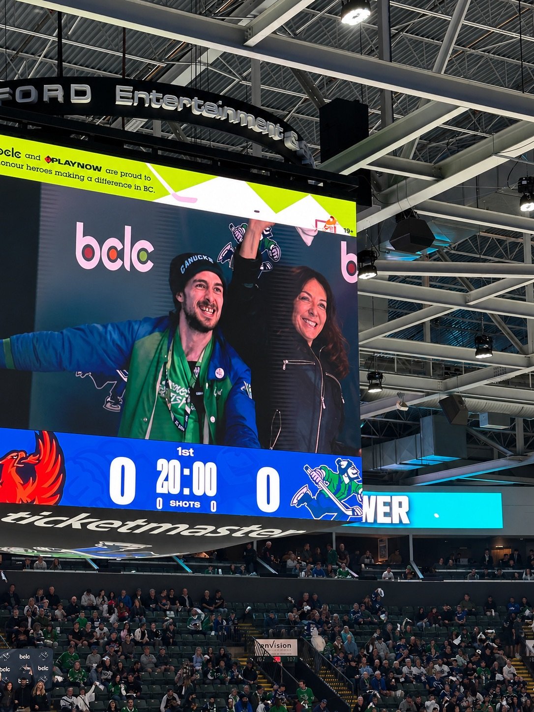 Suzanne on a jumbo tron at a canucks game with a big grin!