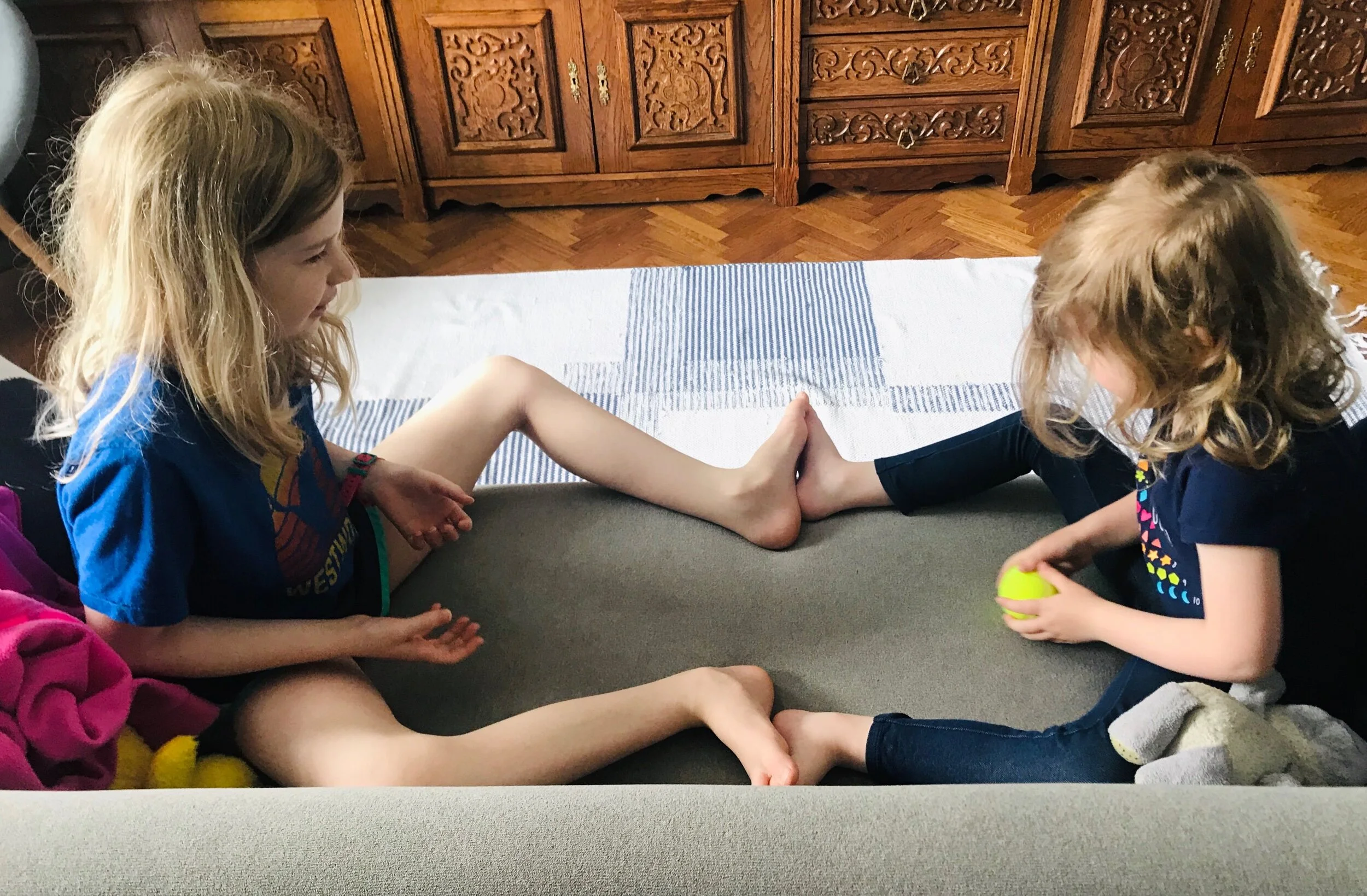 Naomi and Abigail are playing ball on the couch. We brought this tennis ball to use for physical therapy for my back. It’s really come in handy to play with on so many of these inside days.