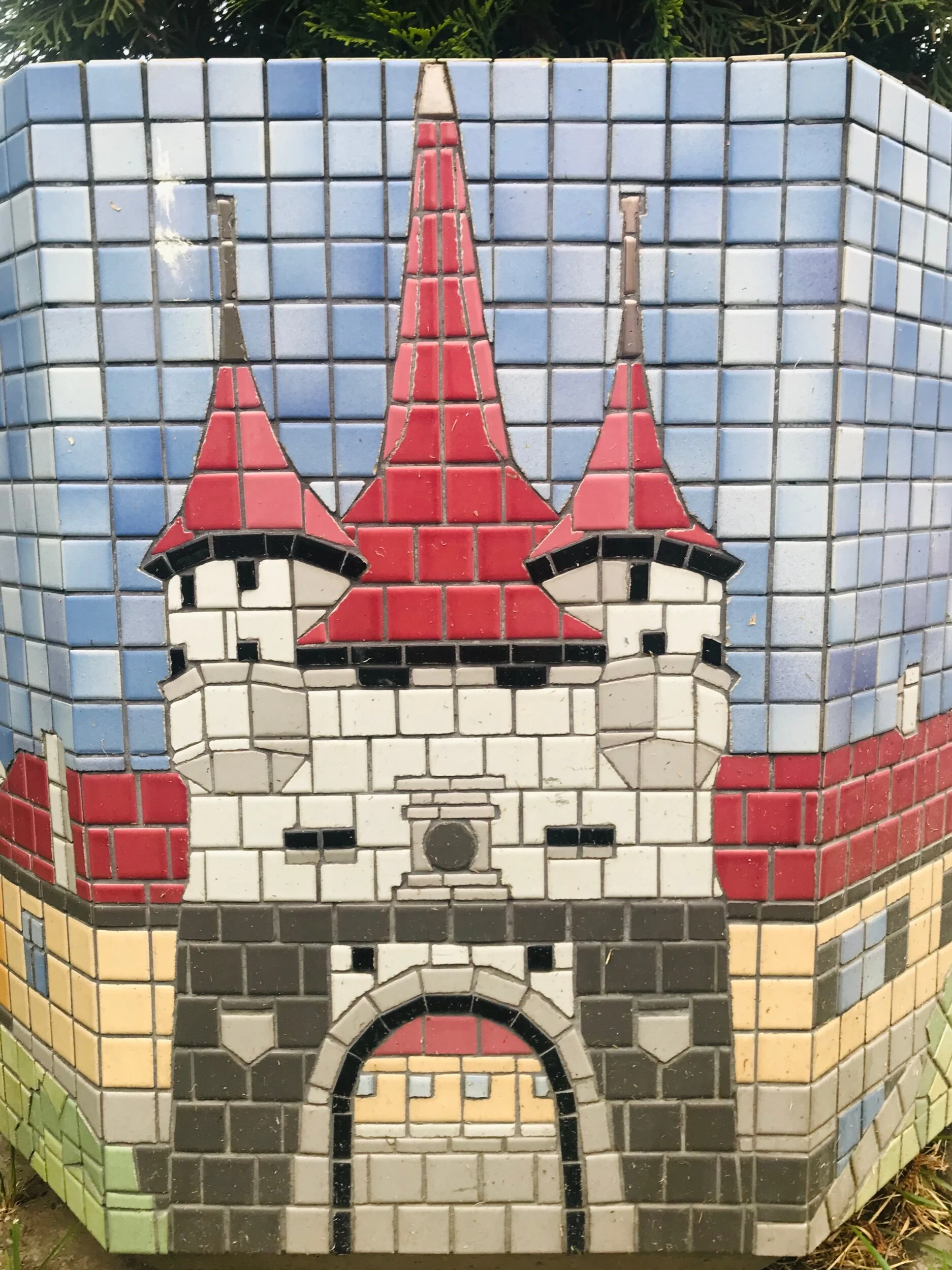 This is a mosaic on a flower pot of an old city gate in Brasov.