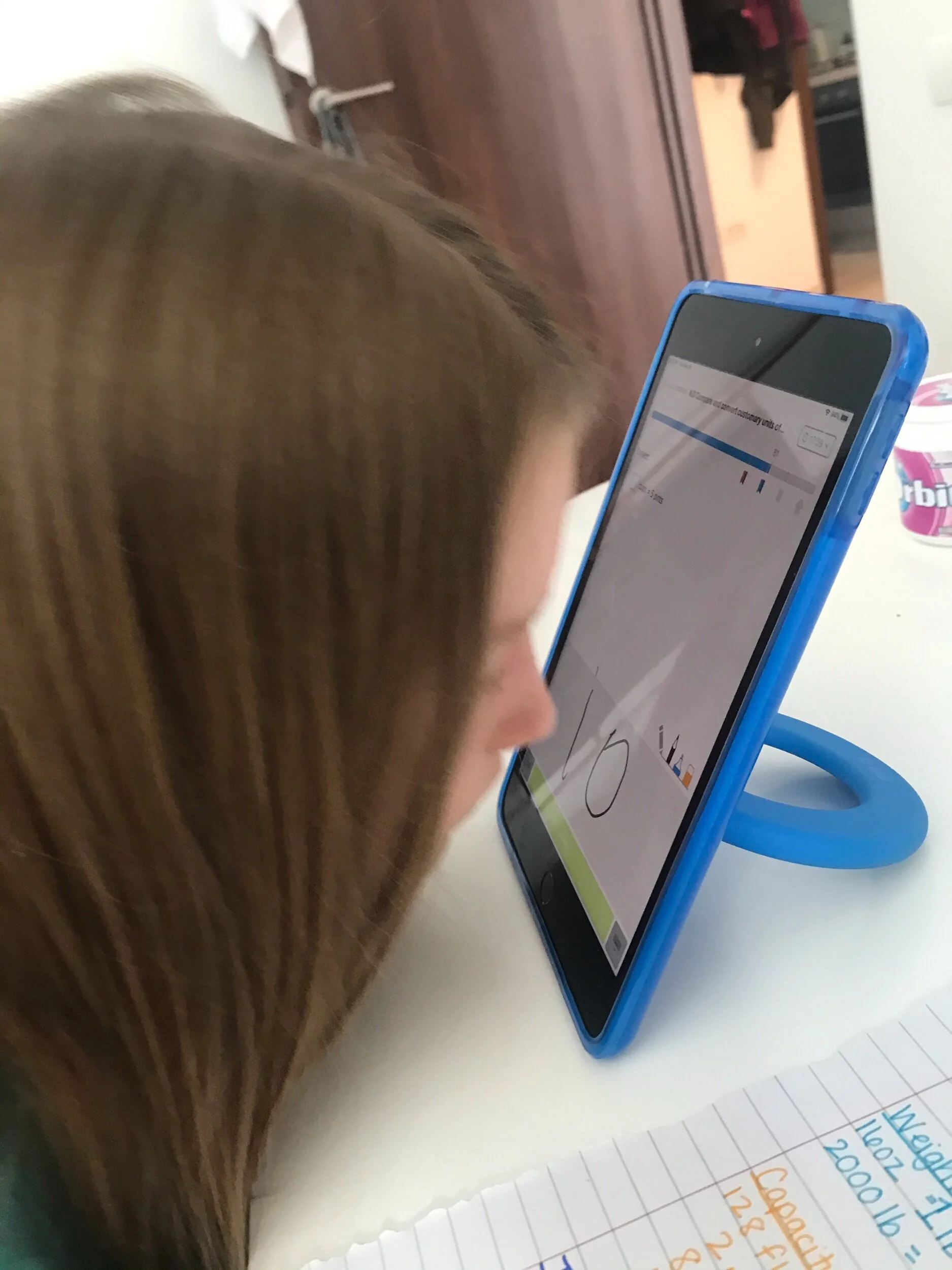 Sometimes you’ve got to try new things during school. Anna is writing her answer with her nose.