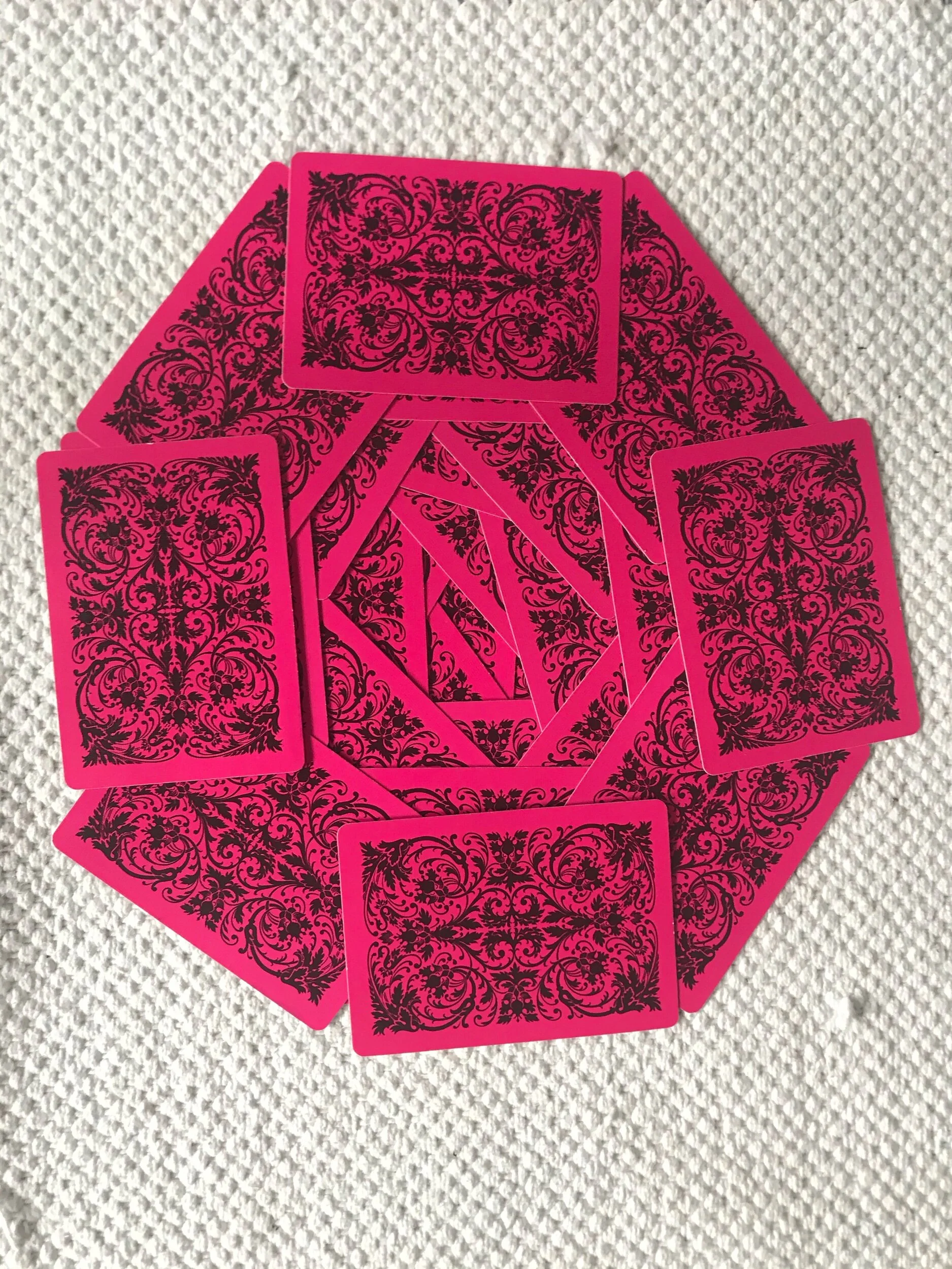 Anna made a “domino train” with cards. When they fell they made this pretty design.