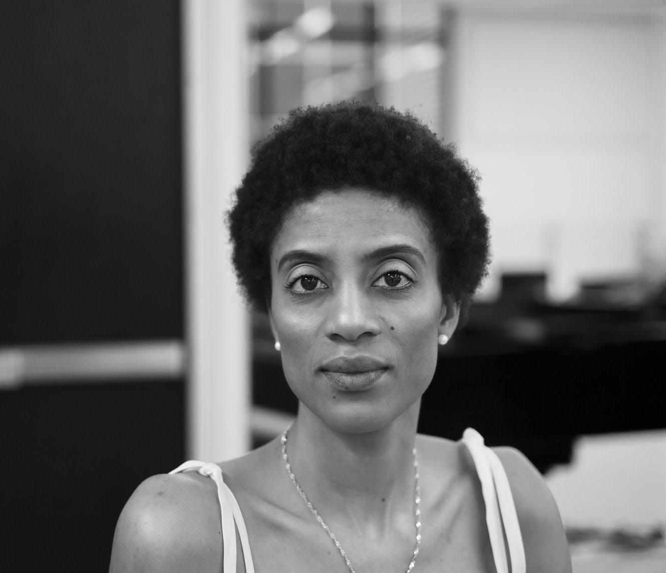 Katlyn Addison looking straight at the camera, black and white photo during studio time
