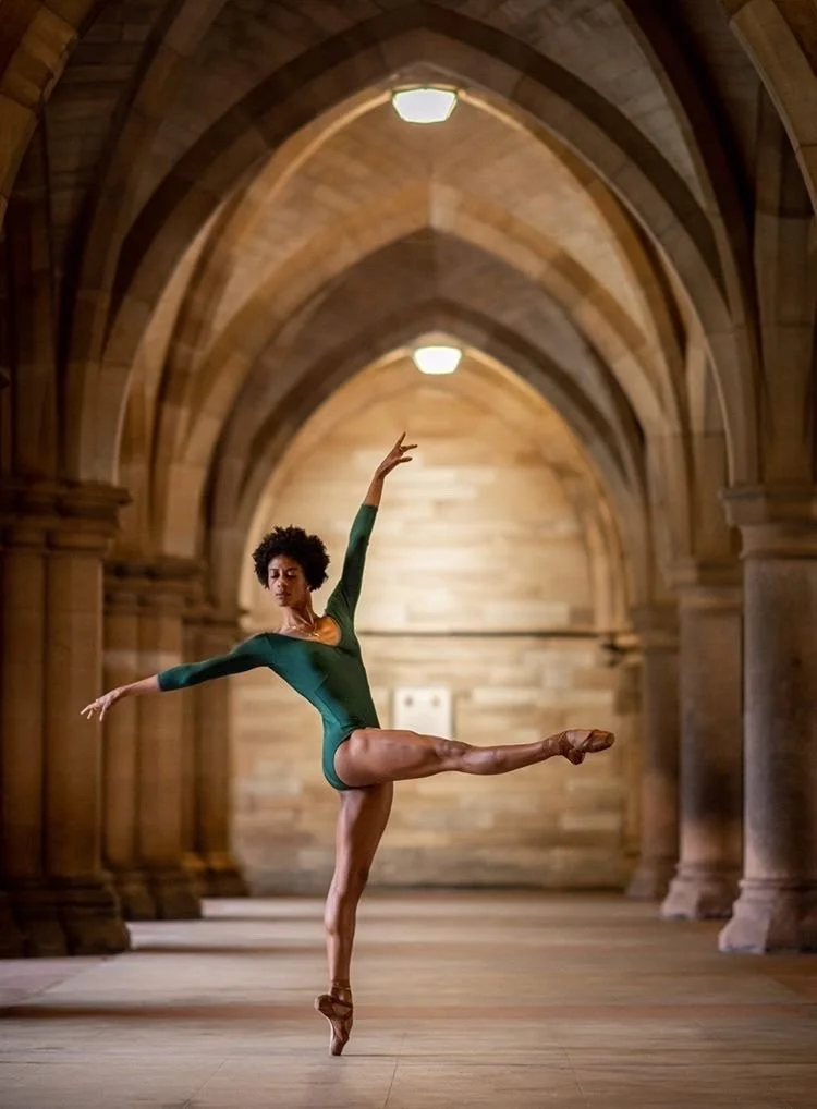 Dancing in Scotland, wearing a green leotard under arches
