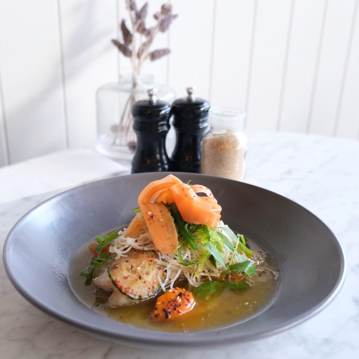 Baked Barramundi with carrot and ginger pur&eacute;e, bacon and dashi broth, rice noodles, picked carrot and hot and sour cucumbers. 

Just one of the amazingly warming new dishes from our winter menu!

Open until 2:30 today

.⁣
.⁣
.⁣
#breakfastinmel