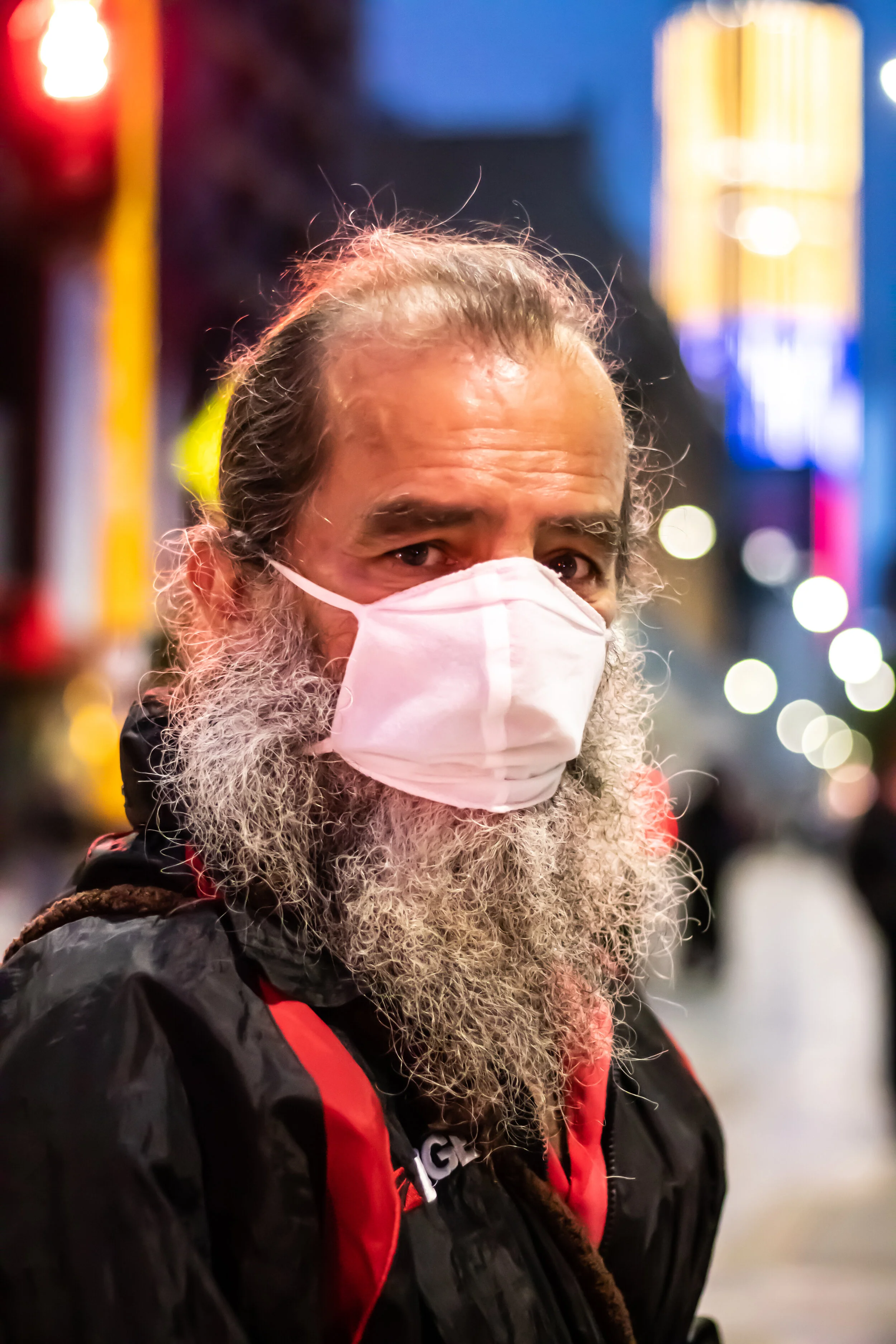 Bearded man selling poems on the street