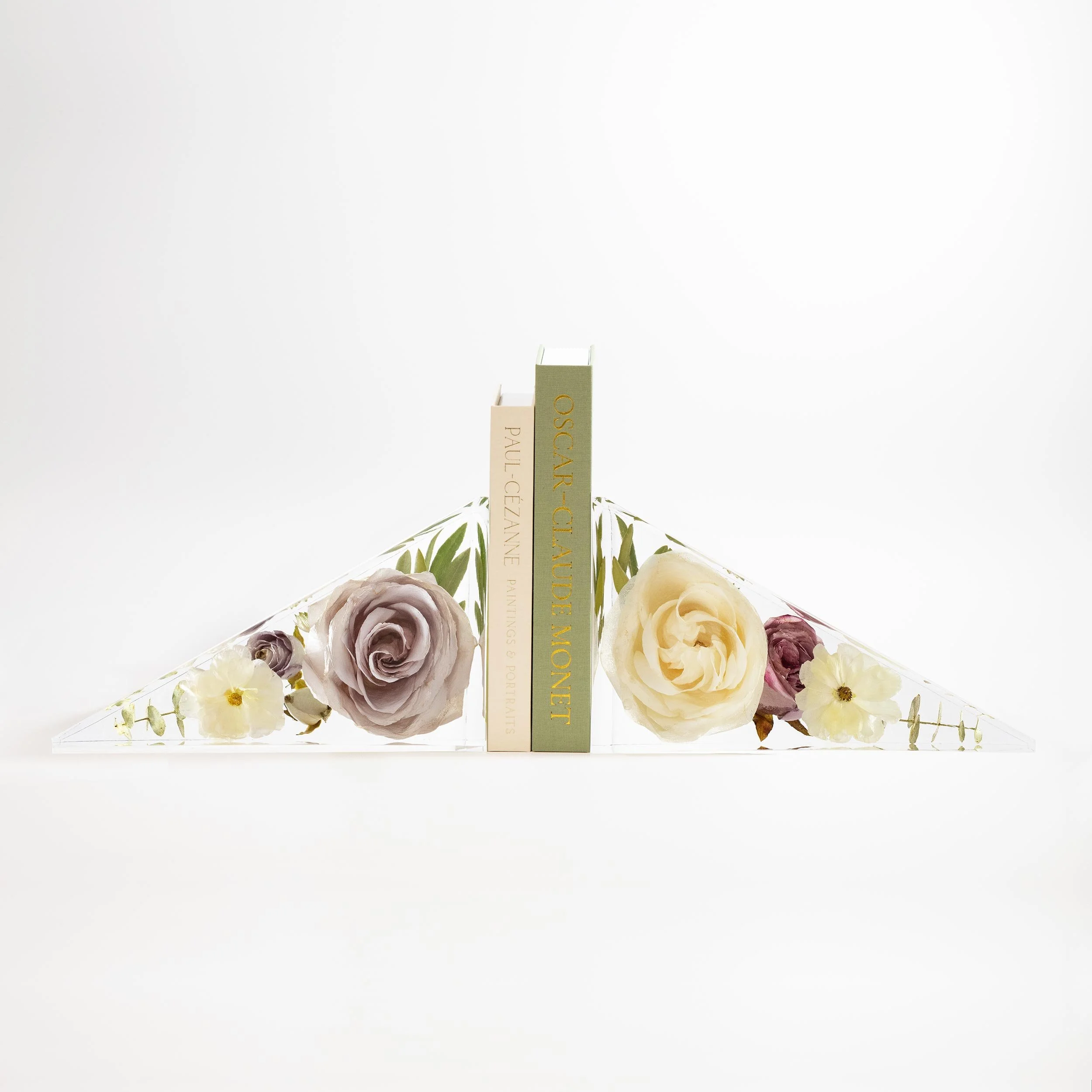 Pair of custom geometric triangle shaped resin flower bookends displaying preserved wedding bouquet blooms for a contemporary bookshelf mantel