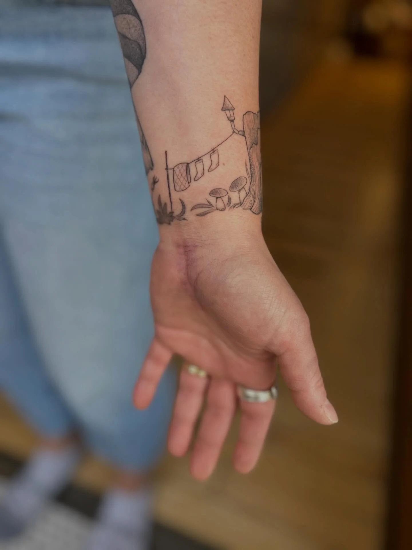 It&rsquo;s giving faery home in a stump, little sockies drying on the line, sweet gal sweeping the bad vibes out. Loved tattooing this wee scene for your Marci. Congratulations on your new home!