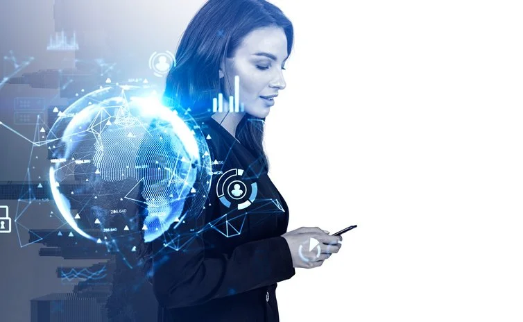 A woman in business attire looking at her smartphone, with digital technology and futuristic holographic graphics surrounding her.