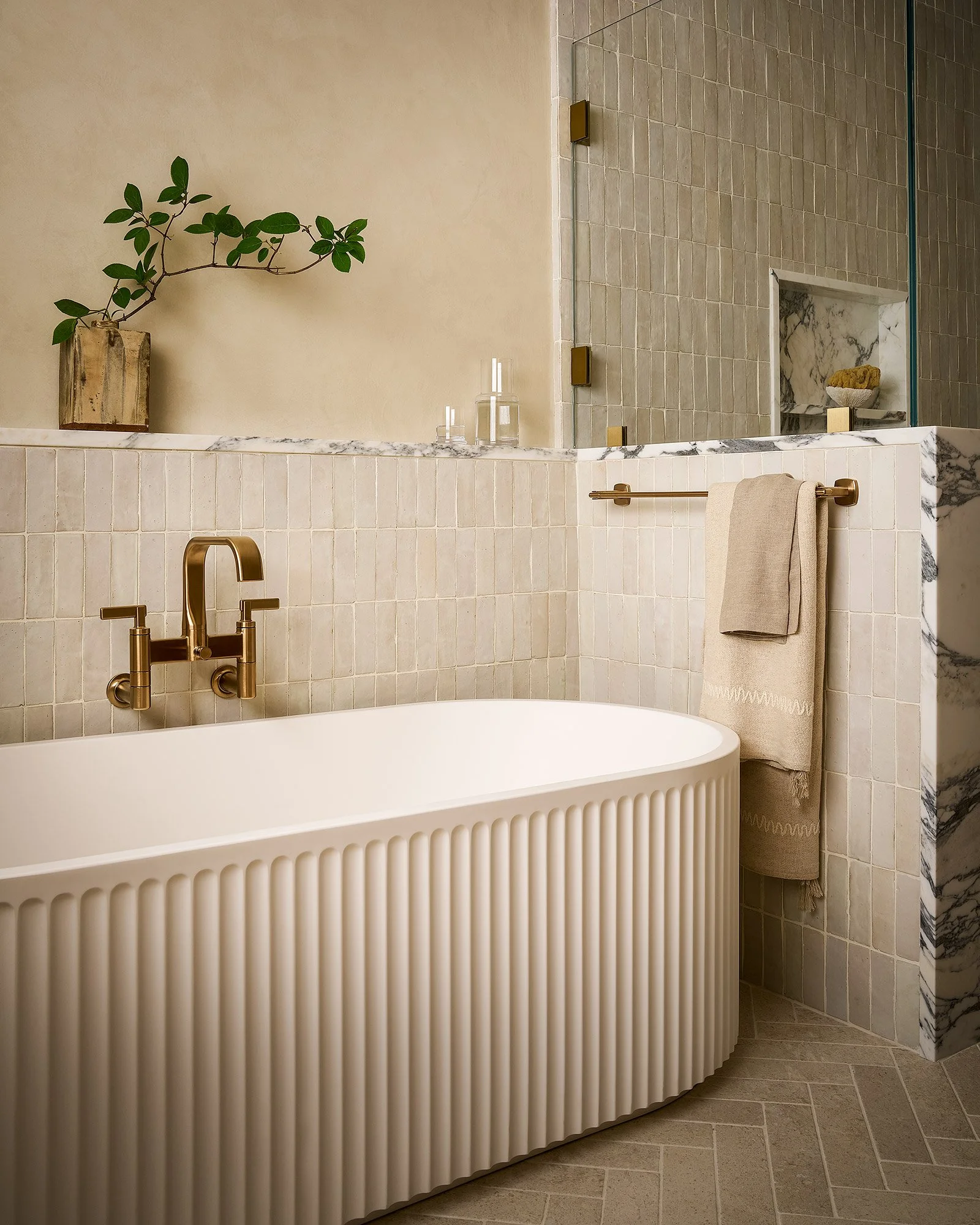 Luxury bathroom with freestanding tub and tadelakt plaster walls.