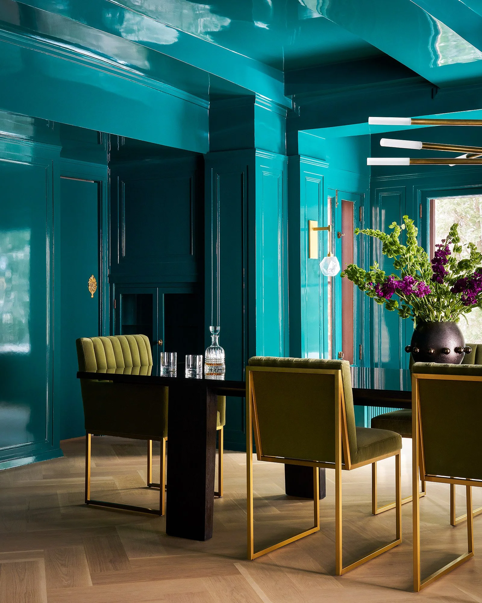 Custom lacquered dining room with high-gloss  finishes and luxury design, angled view.