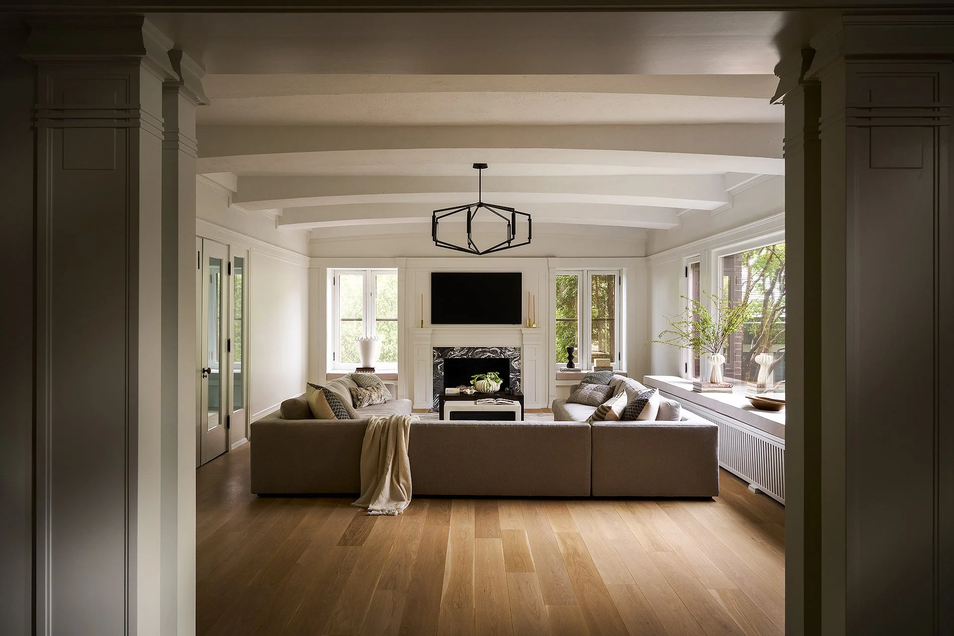 High-end living room design with custom marble fireplace, front view.