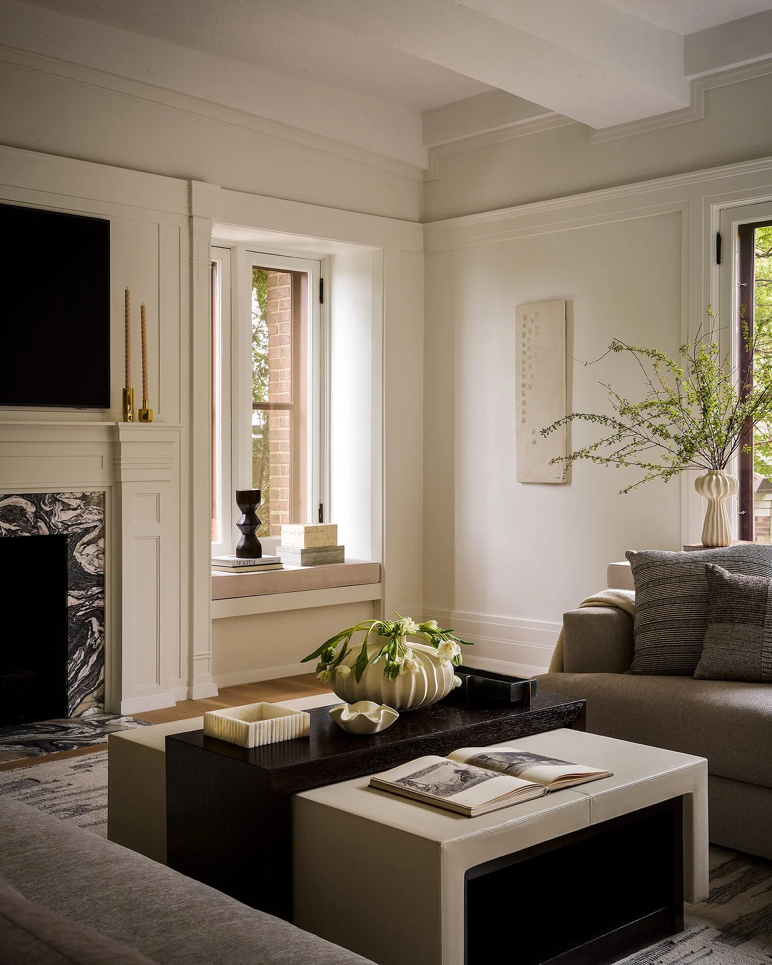 High-end living room design with custom marble fireplace, angled view.