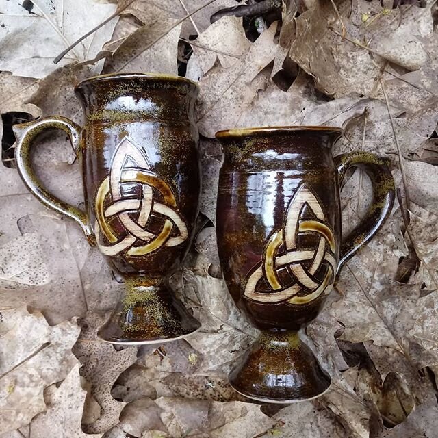 Pretty proud of the latest batch of Irish Coffee mugs I made... Here are the two I glazed in Amber teadust. Each mug is wheel thrown with a wheel thrown base, carefully attached during trimming. Then the handle is added and stamped with a knotwork st