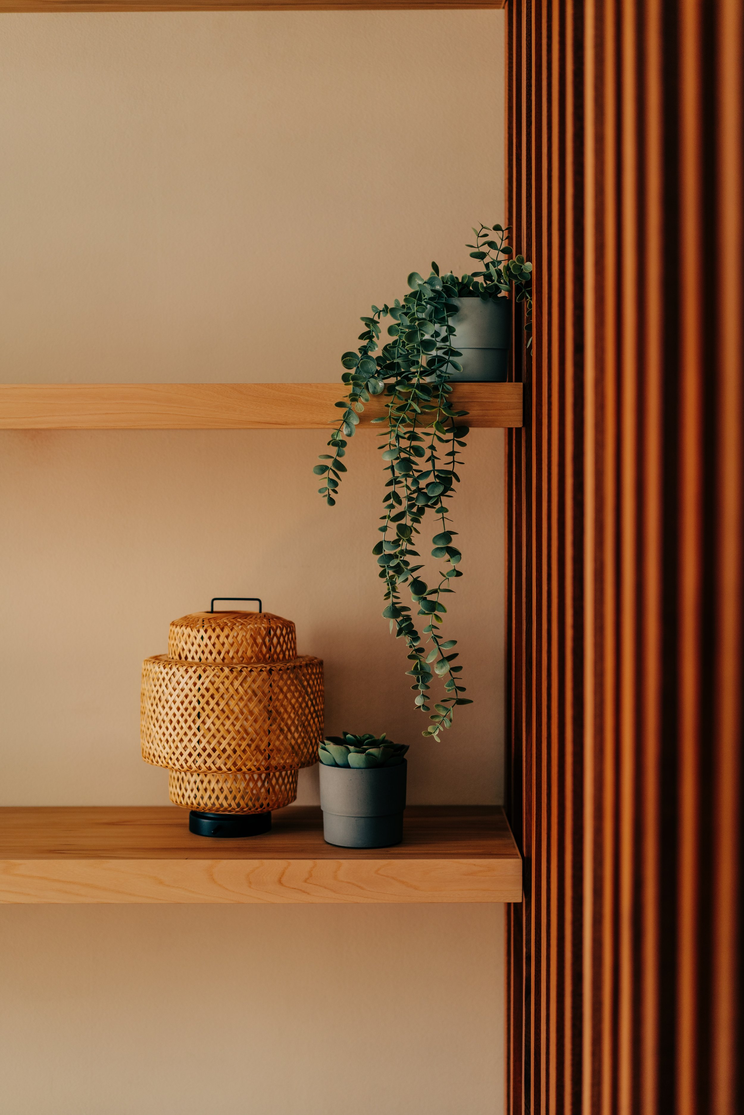 Gerrard St. E., African mahogany slatted screen with grey elm floating shelves and mantel