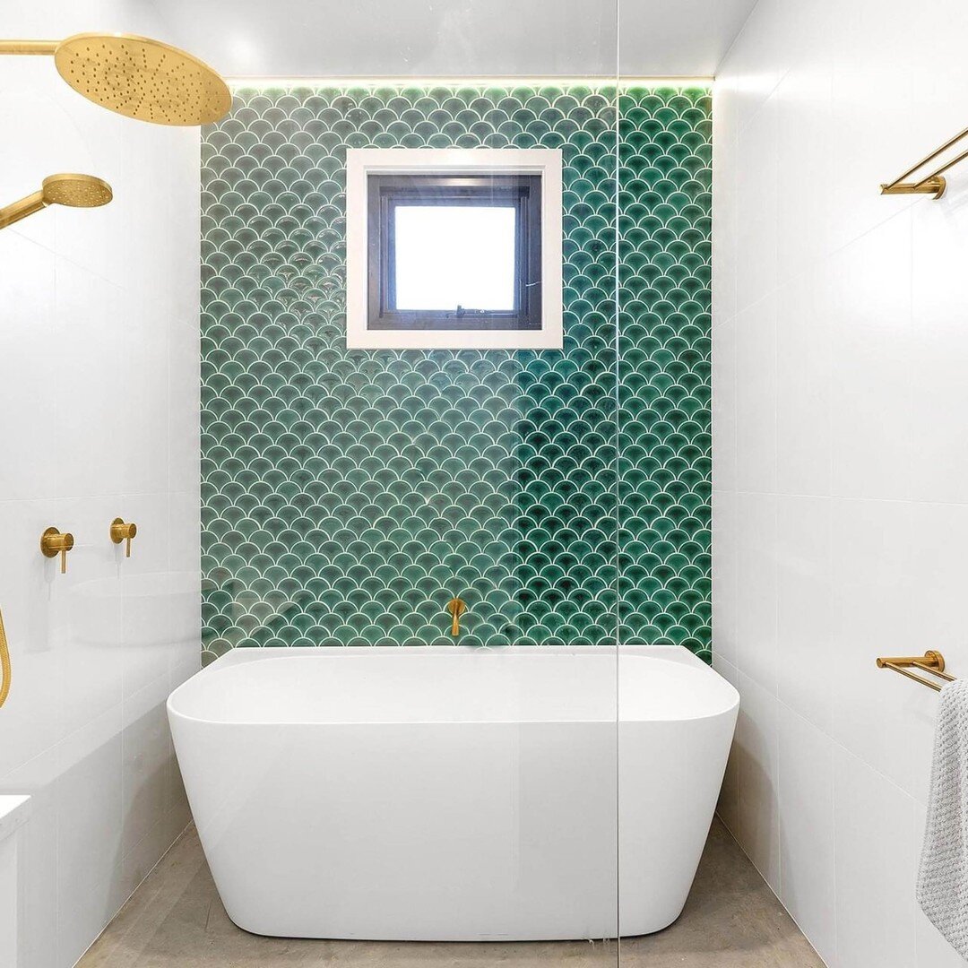 Don't be afraid to add a splash of colour to your bathroom! These emerald feature tiles paired with stunning brass tapware are a match made in heaven!