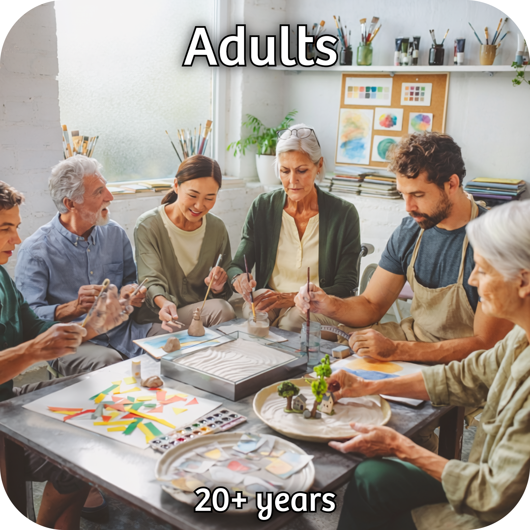 Group of adults sat around a table undertaking a variety of craft activities together.