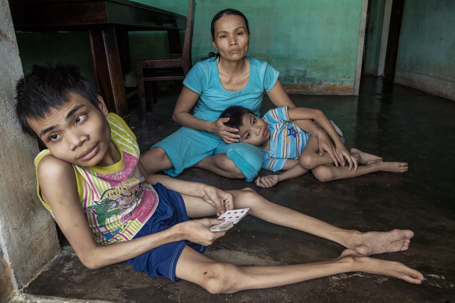NEITHER TAN TRI NOR TAN HAU CAN WALK AND ARE SEVERELY MENTALLY IMPAIRED. THEIR MOTHER, VO THI NHAM, SPENDS ALL HER TIME CARING FOR HER BOYS, 2010