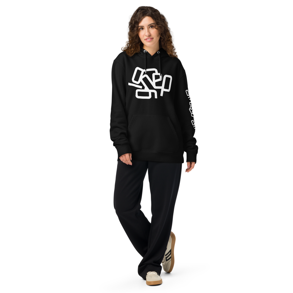 Ignored hoodie – female model in black hoodie with white abstract message. Typowear design with a message of quiet resistance and mental clarity.