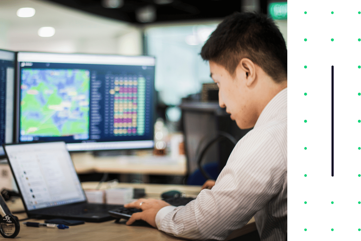 Man working on several computer screens