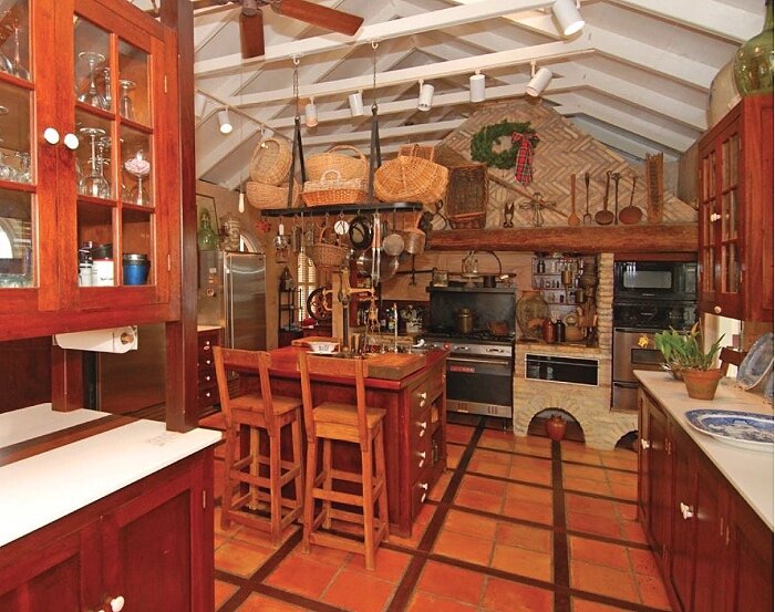 Our first full kitchen and still the largest in terms of the totality of cabinetwork. In a restored sugar estate Great House this kitchen was done in 1986 using silver Balli as a face wood with some Greenheart. Counters are in Corian and Mahogany.