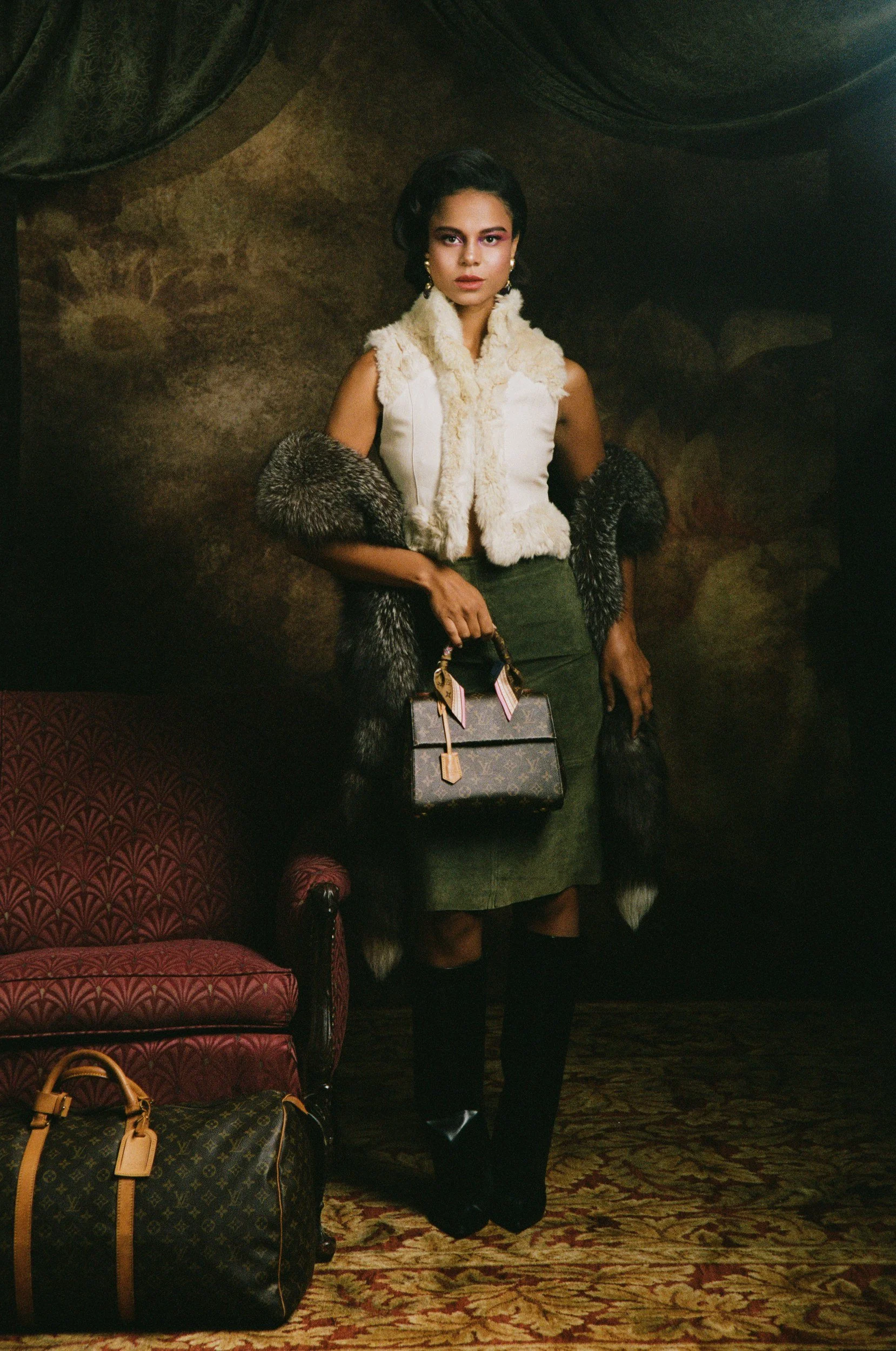 Vintage fashion campaign on painted backdrop with luggage at Lightbox OKC photo studio