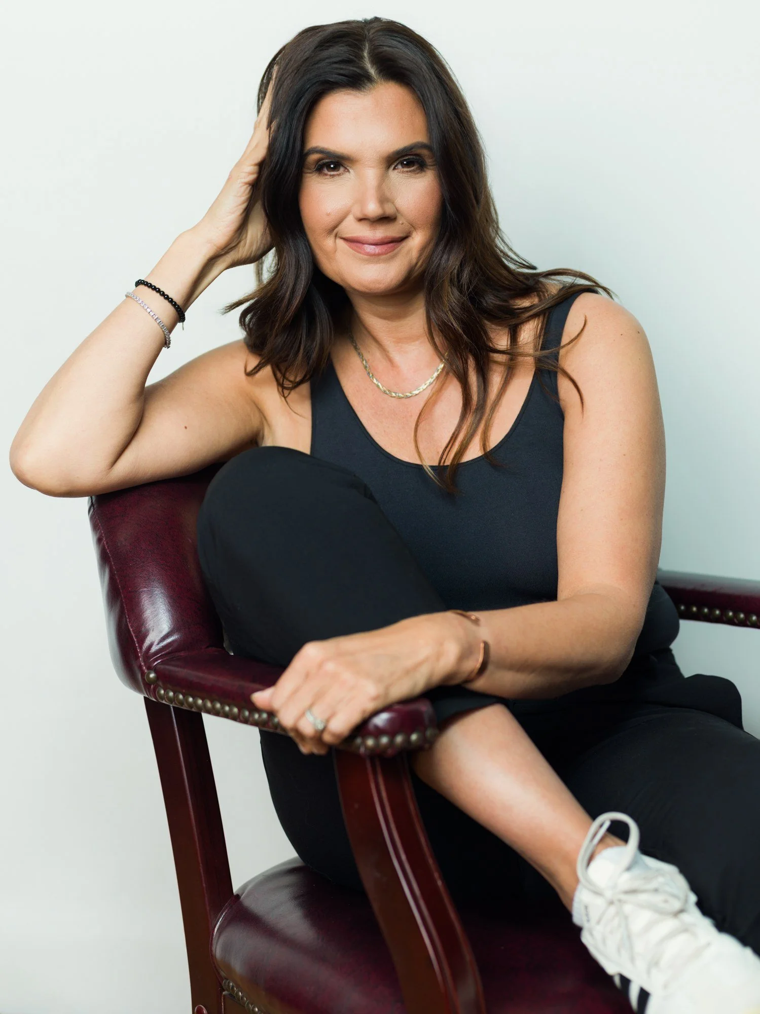 Branding portrait in leather chair on white wall at Lightbox OKC, Oklahoma City studio rentalProfessional headshot in white turtleneck on gray seamless at Lightbox OKC, Oklahoma City headshot studio