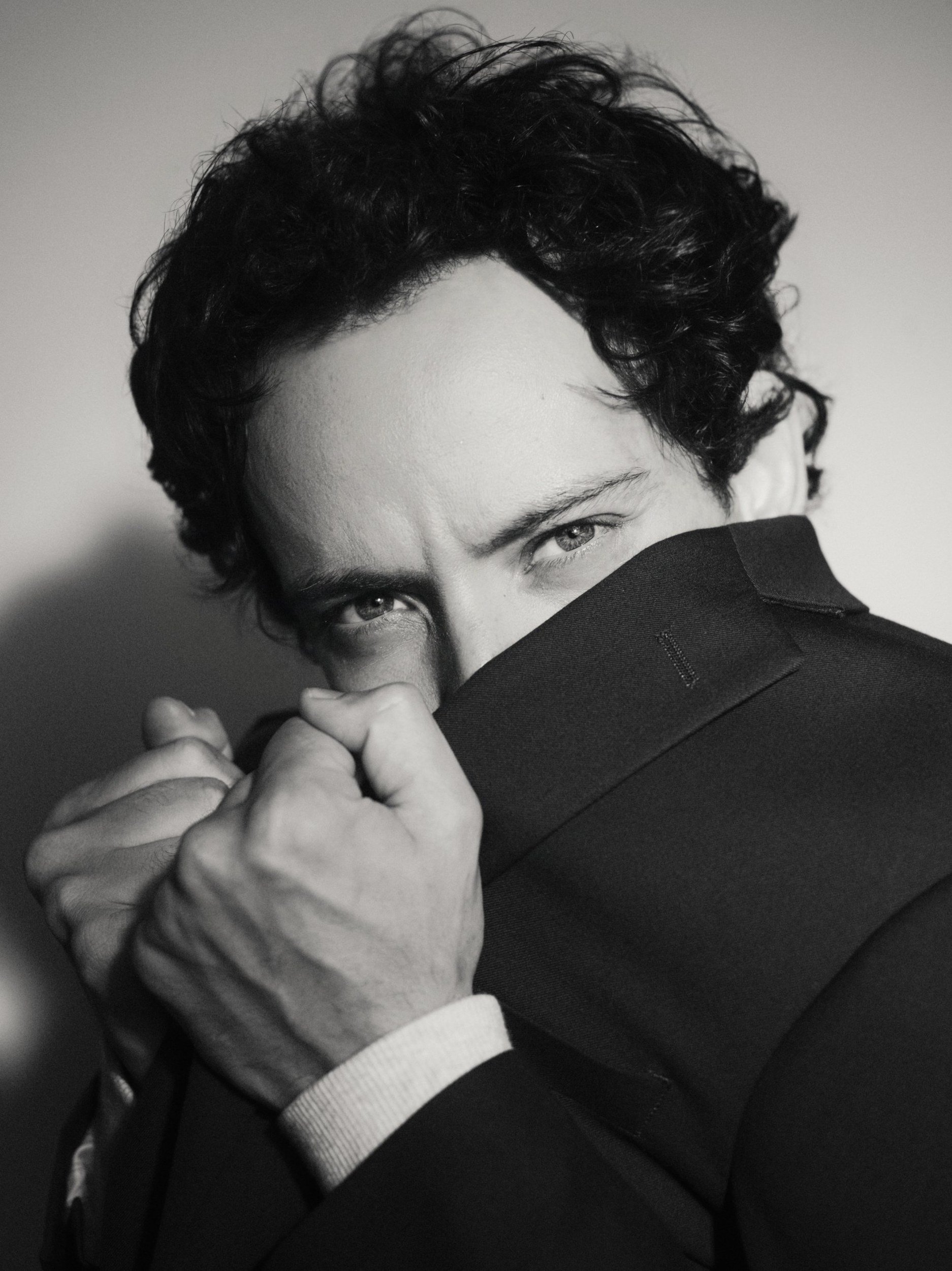 Black and white portrait with jacket collar raised, Lightbox OKC photo studio