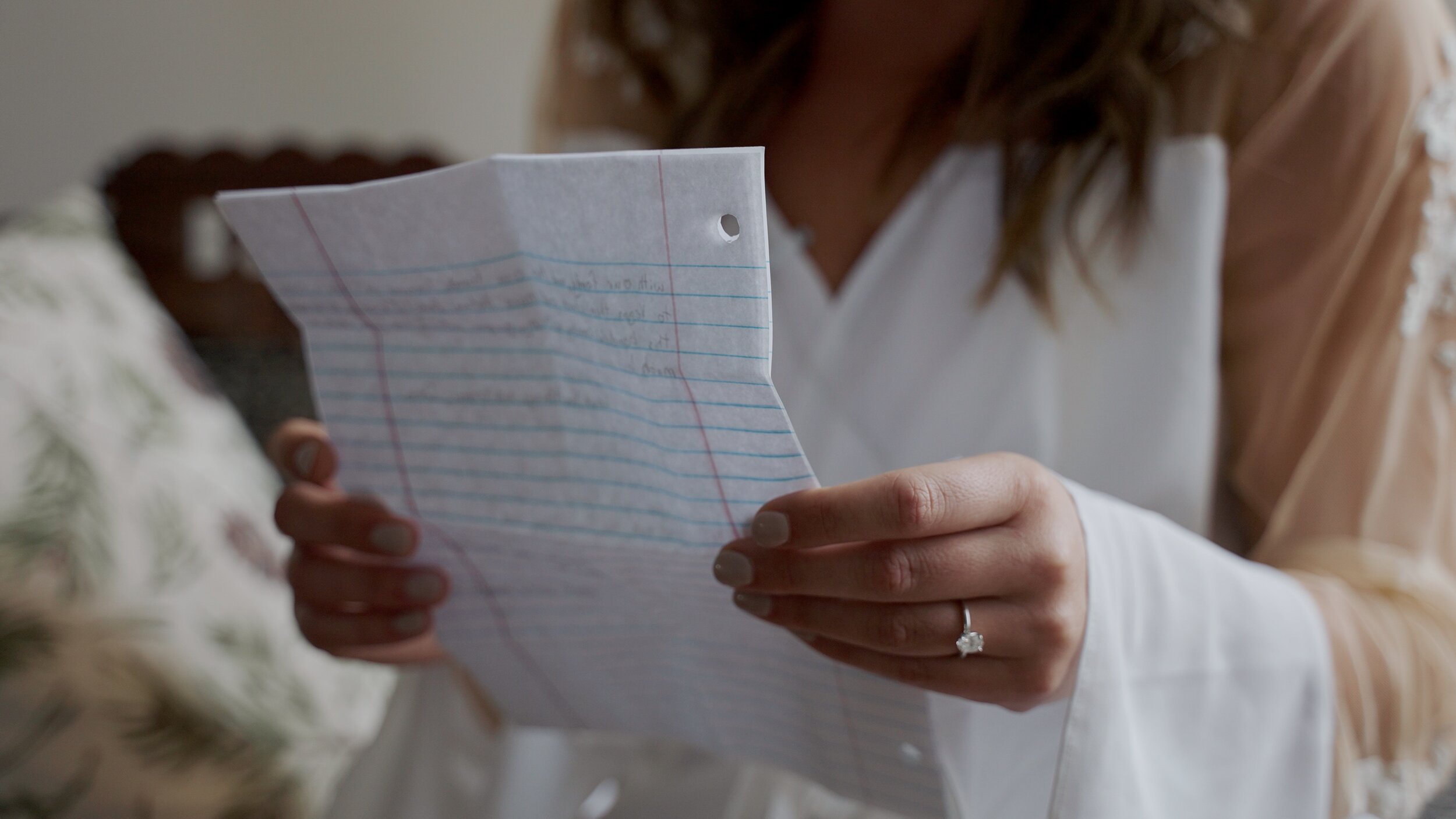 Midwest Wedding Videographer captures emotional bride reading letter from groom