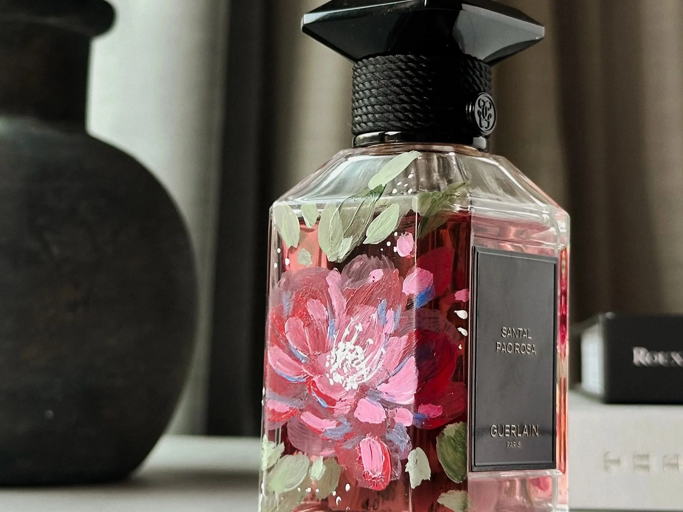 Hand-painted floral design on a Guerlain perfume bottle, featuring delicate custom artwork for a personalized luxury gift or event piece - Didi Letters, Montreal Artist