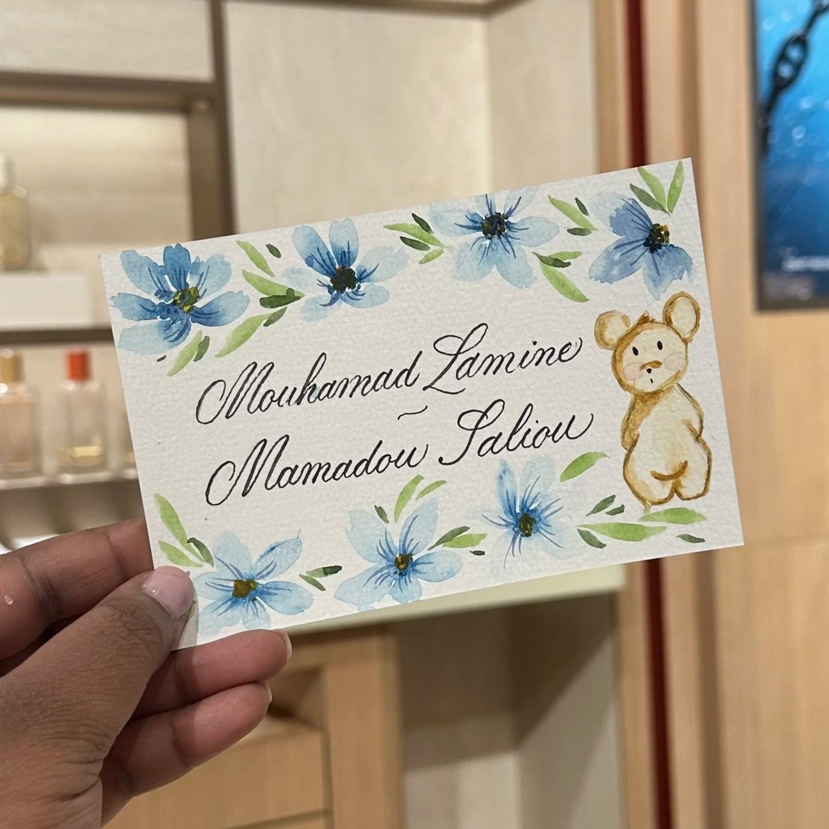 Watercolor teddy bears with calligraphy names and floral accents, celebrating the birth of twins with a personalized touch – Didi Letters, Montreal Artist