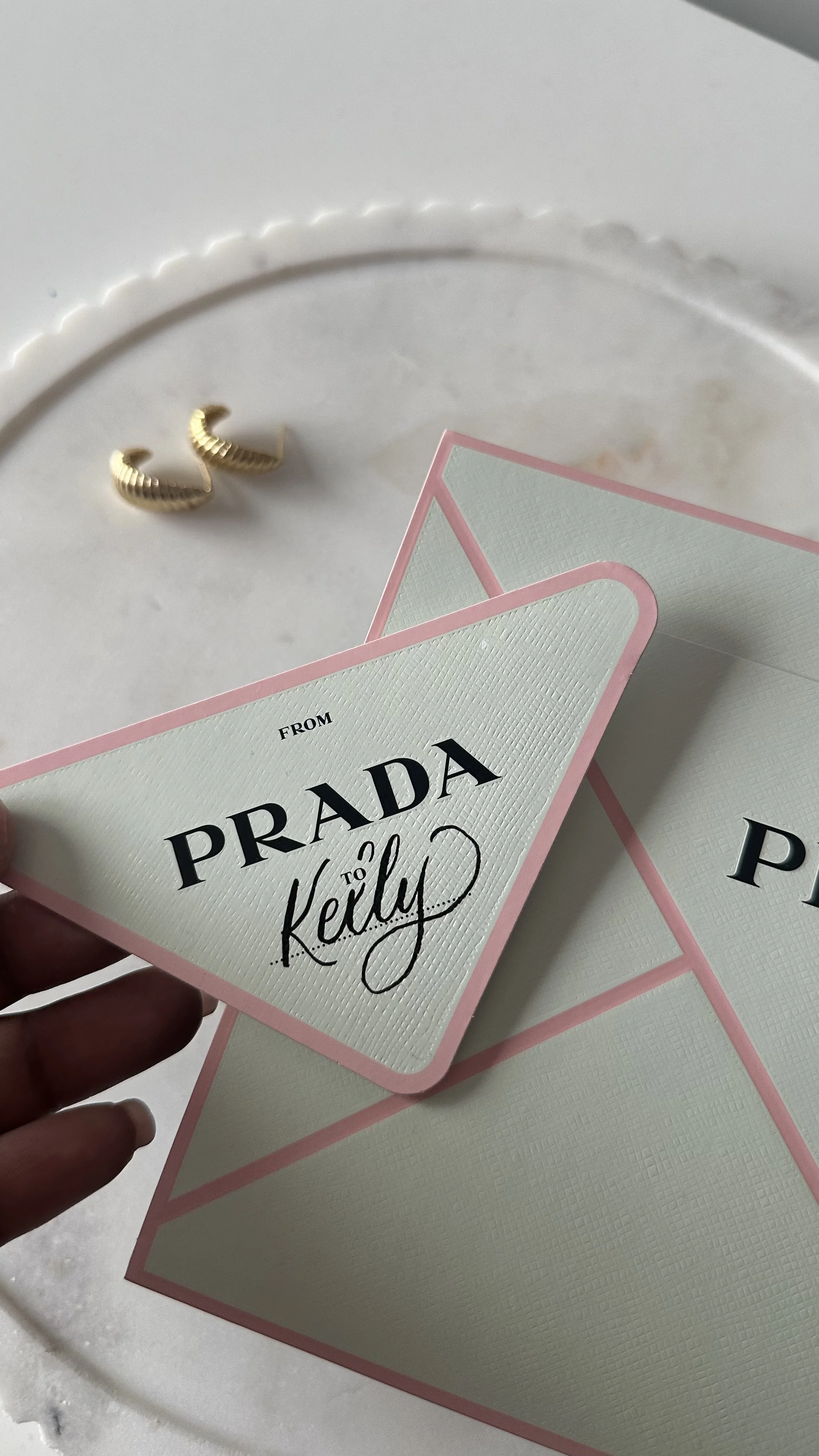 Handwritten calligraphy name on a Prada card, showcasing elegant personalized lettering for a luxury event or gift - Didi Letters