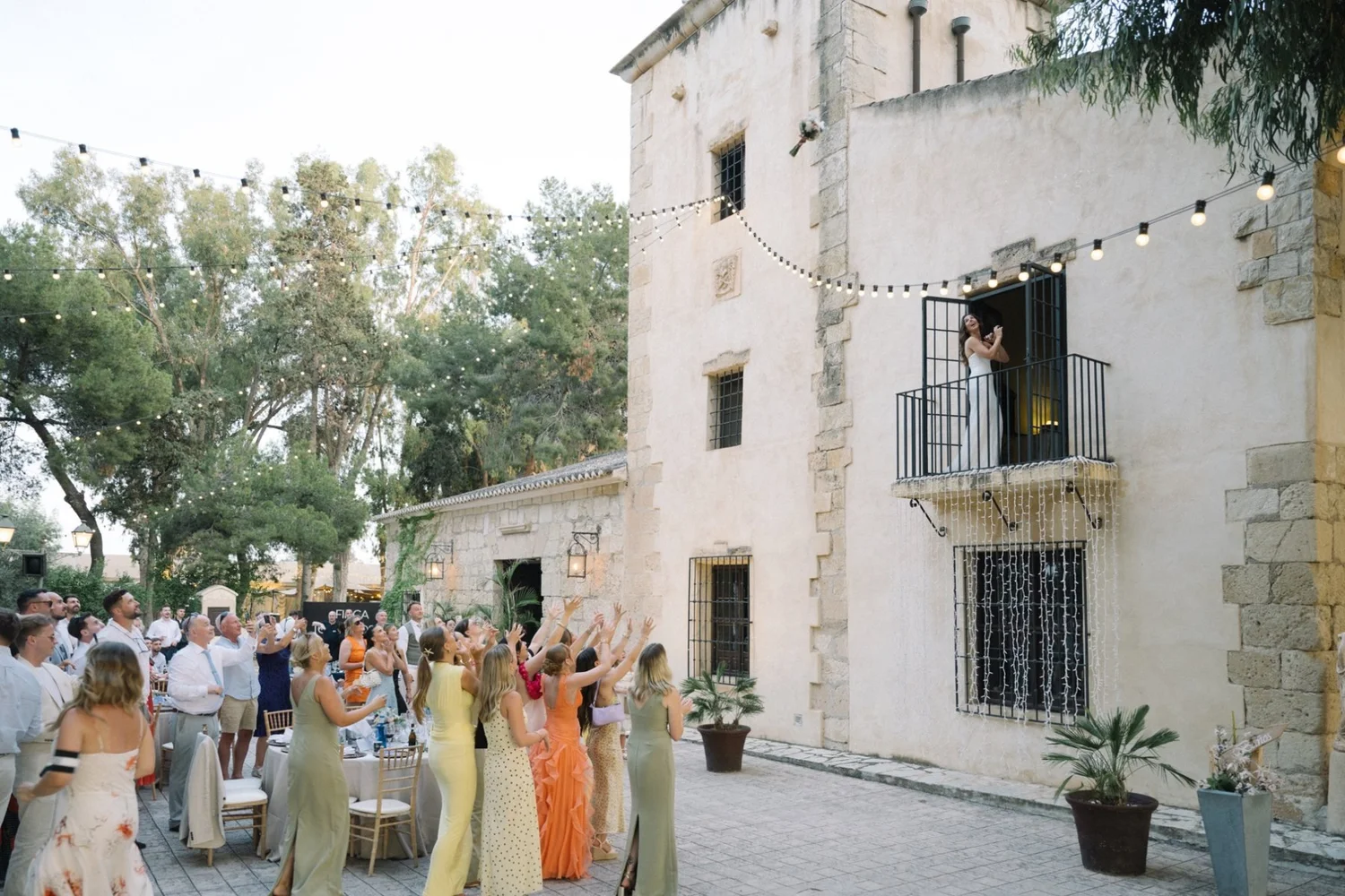 Tilly tossing her bouquet from the balcony
