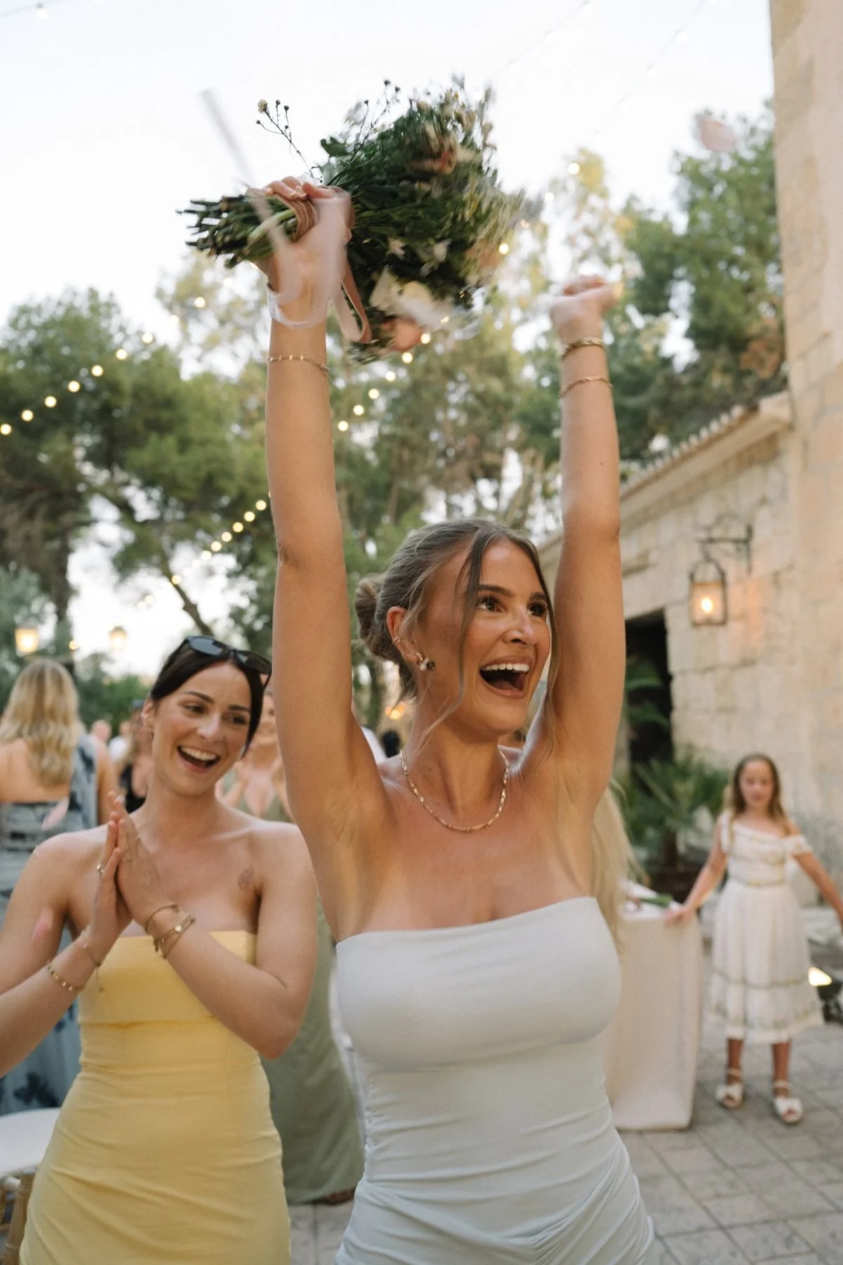 Wedding guest celebrating after catching the bouquet