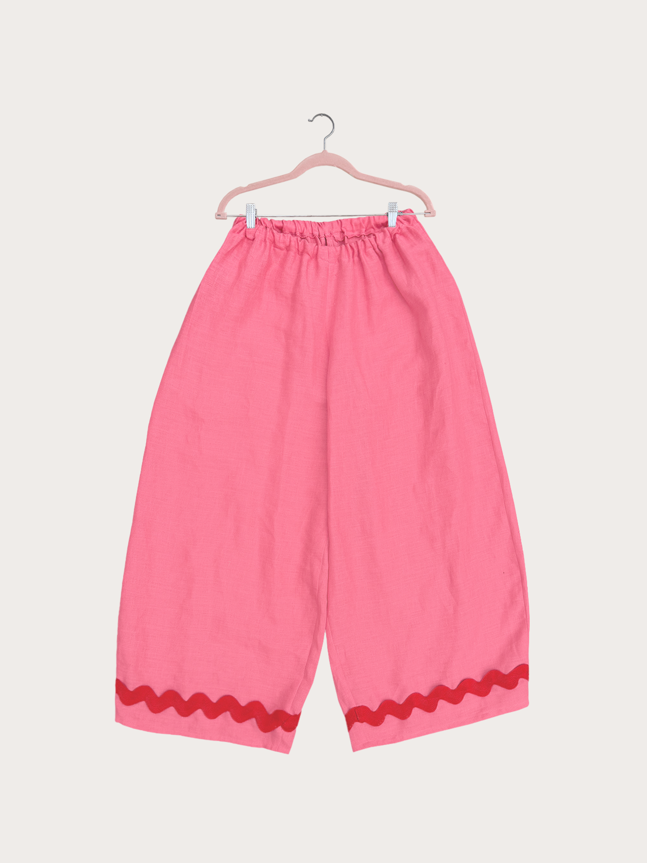 The playground pants are high waisted with an oversized comfy fit. Super stretchy at the waist with a wide barrel leg shape. Back pockets with a chunky ric rac trim at the hem.