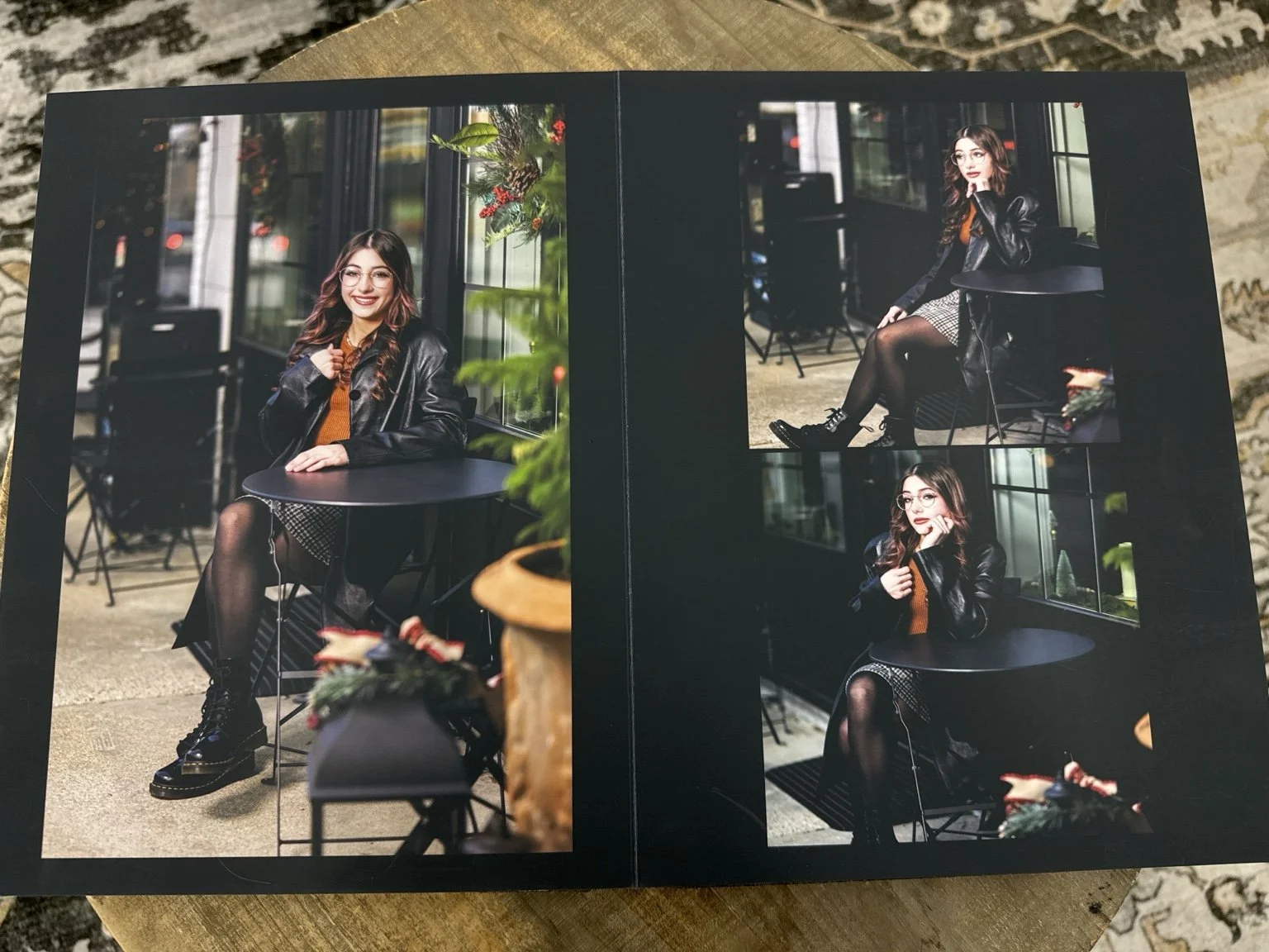 Open handcrafted senior portrait album featuring custom-designed portrait spreads