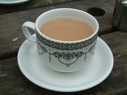 Photo of a cup of black tea with milk